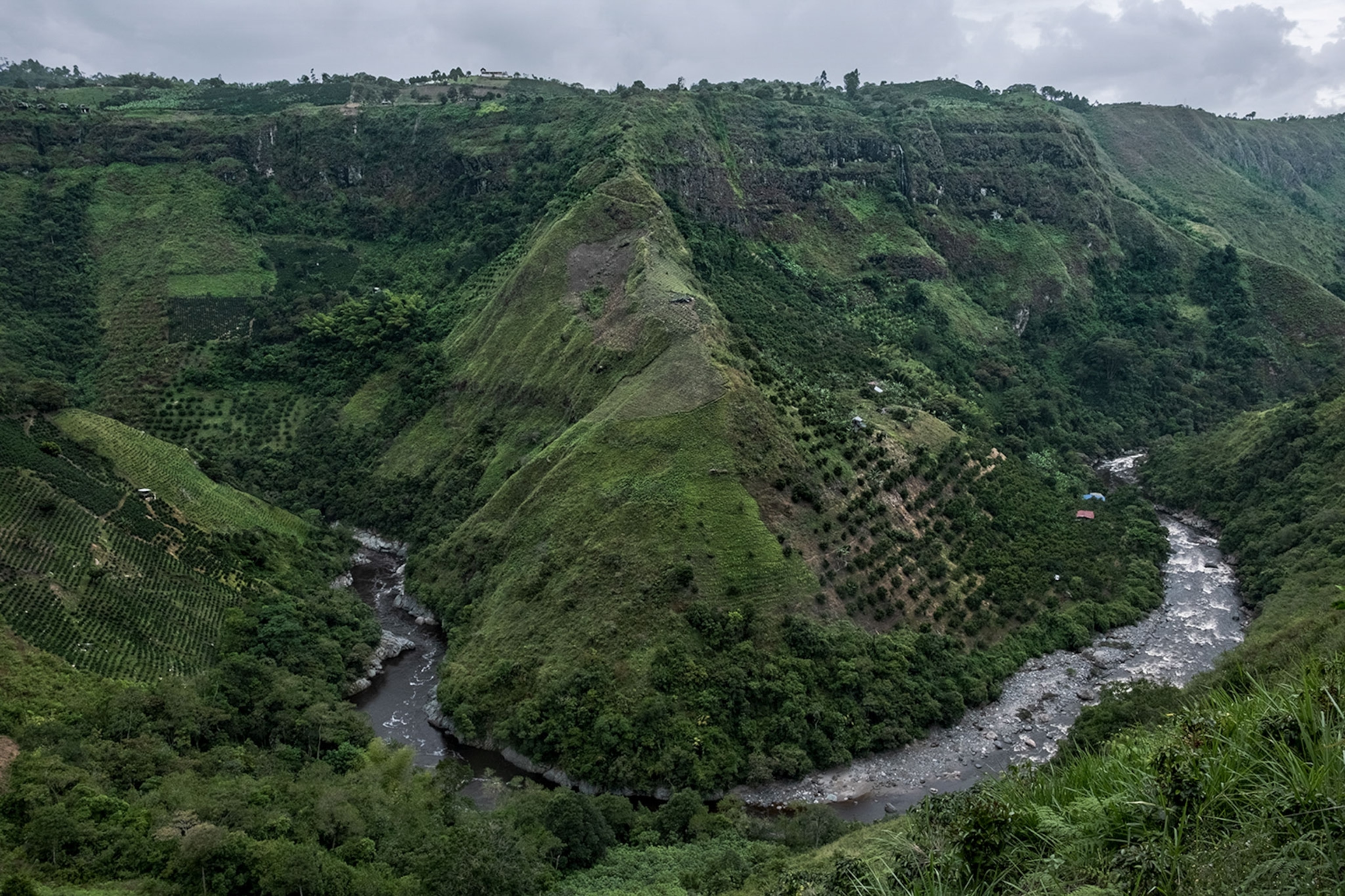 a view of the Magdalena River flowing around a mountain in Colombia