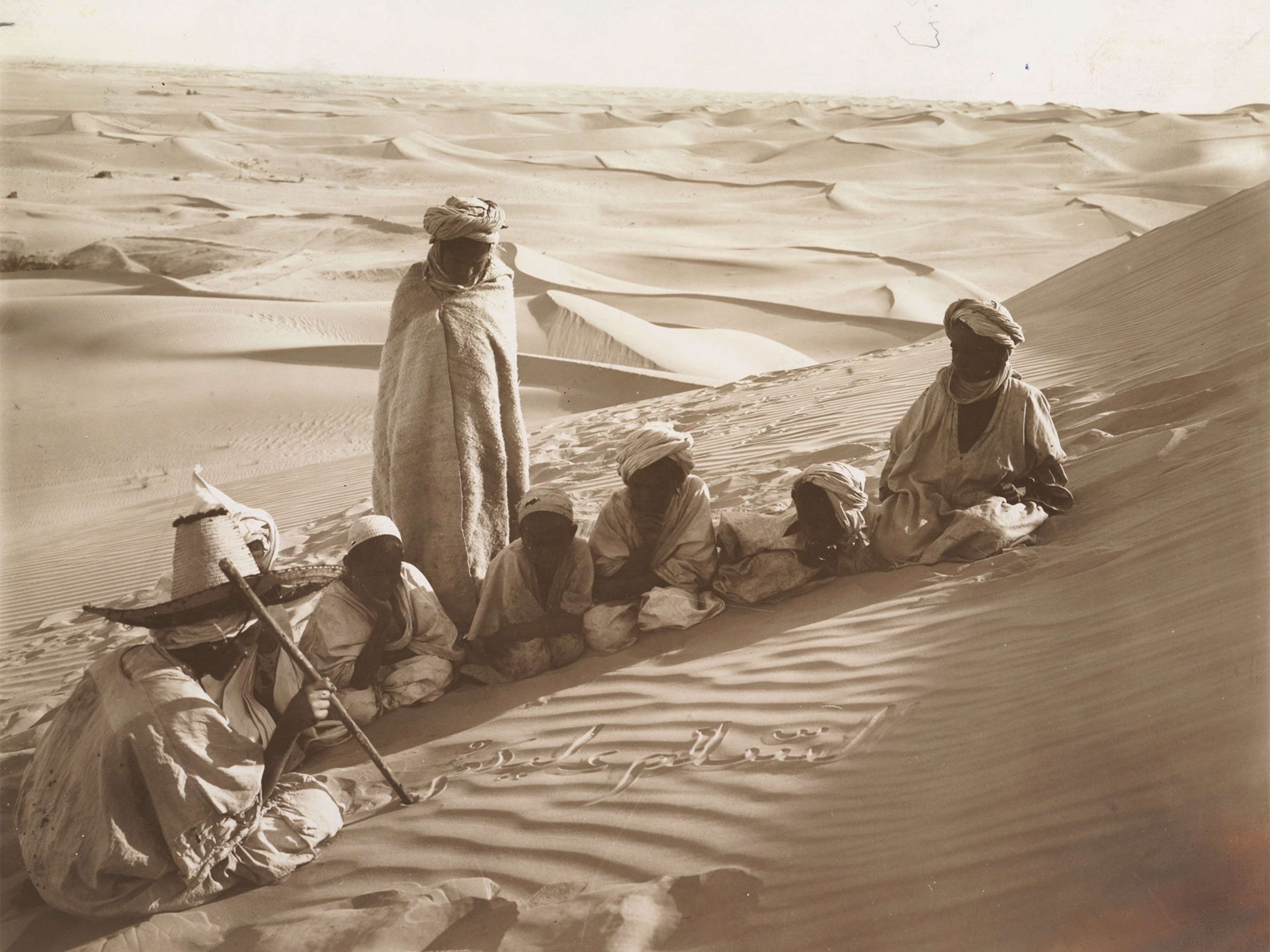 students writing in sand in the Sahara Desert in Tunisia
