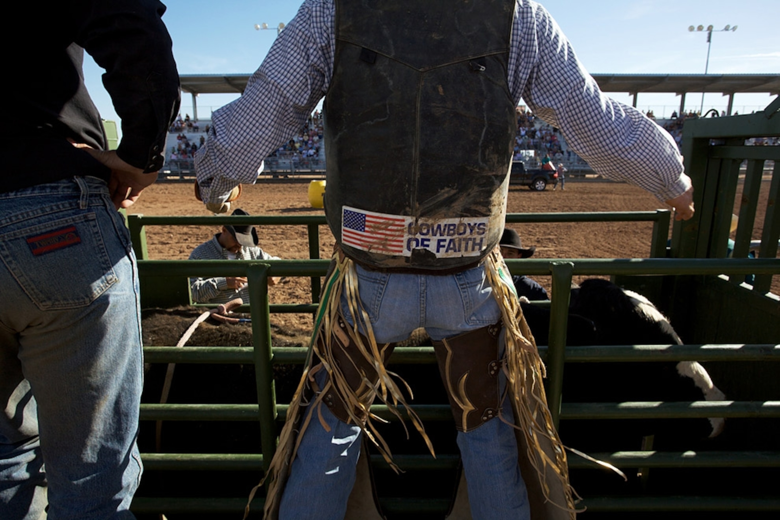 A cowboy looking out over the arena