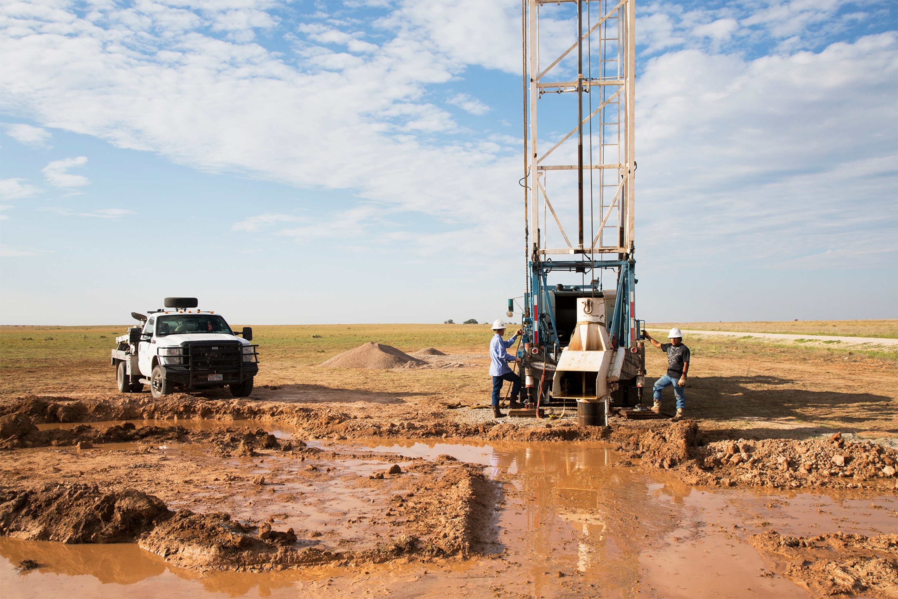 a farmer walking through a dust storm