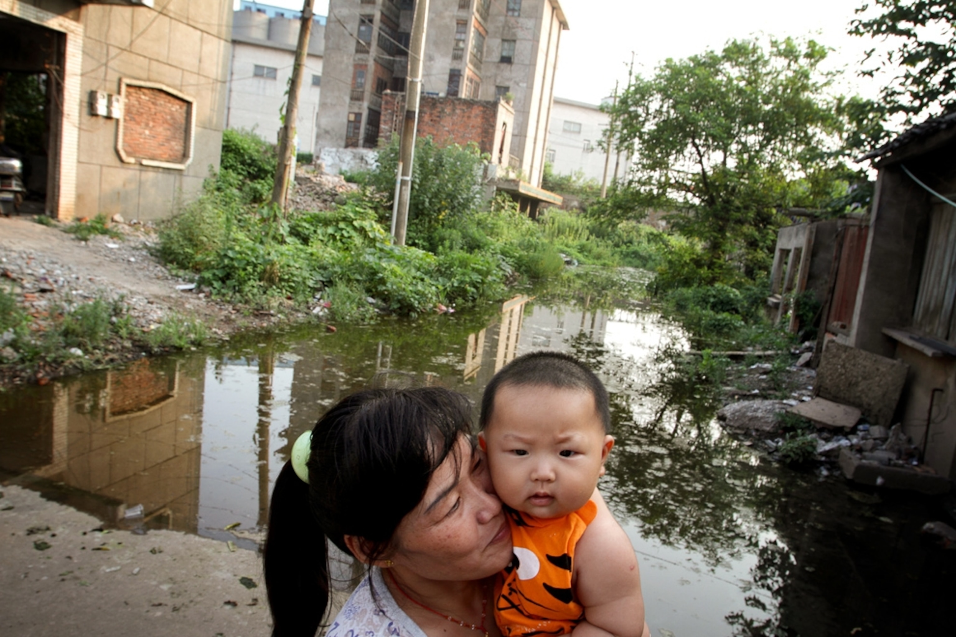 A woman holds her child in the town of Yueyang