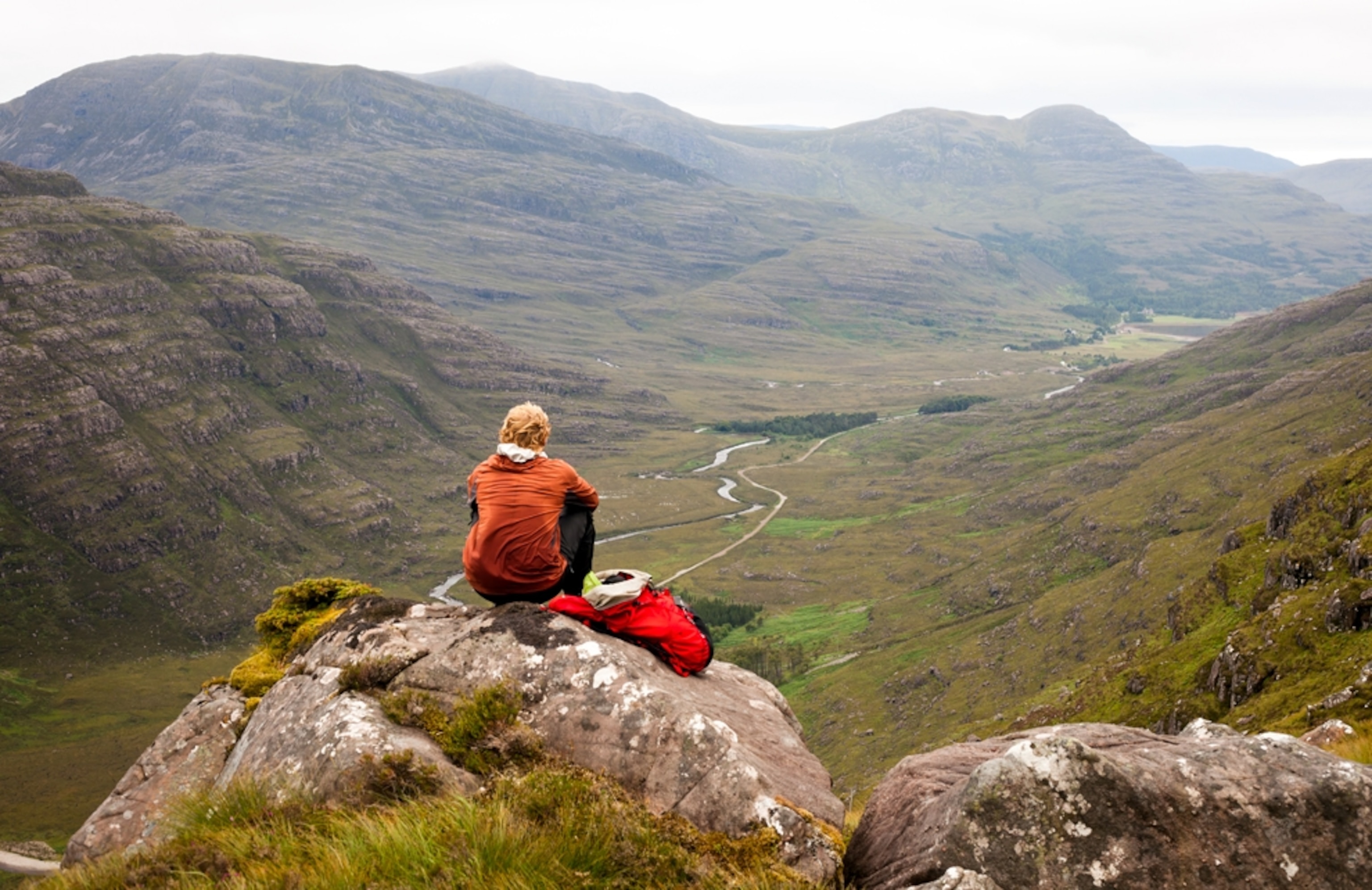 Alastair Humphreys sits at dawn, alone in the mountains of Scotland
