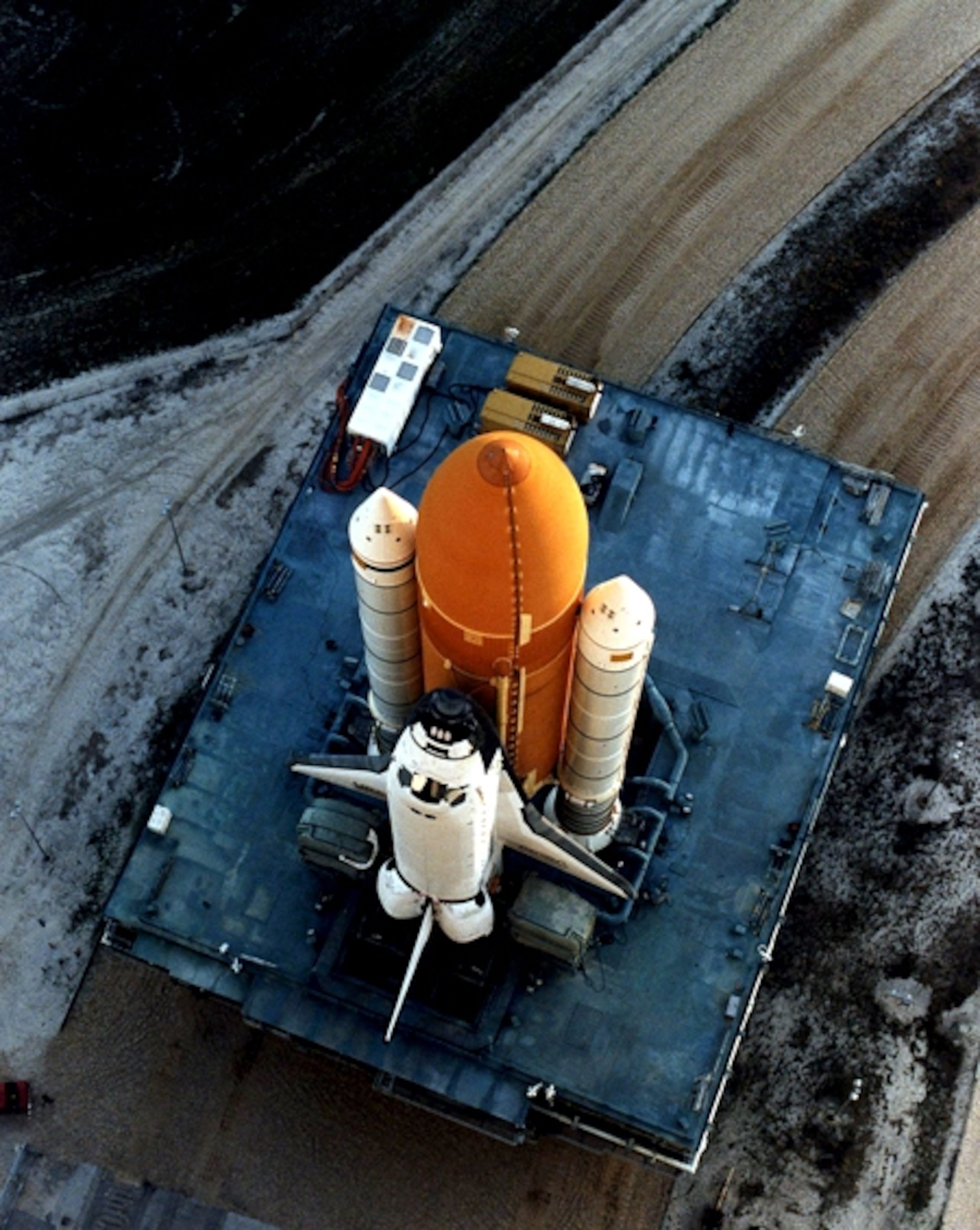 the NASA space shuttle Discovery on a mobile platform headed toward the launch pad.