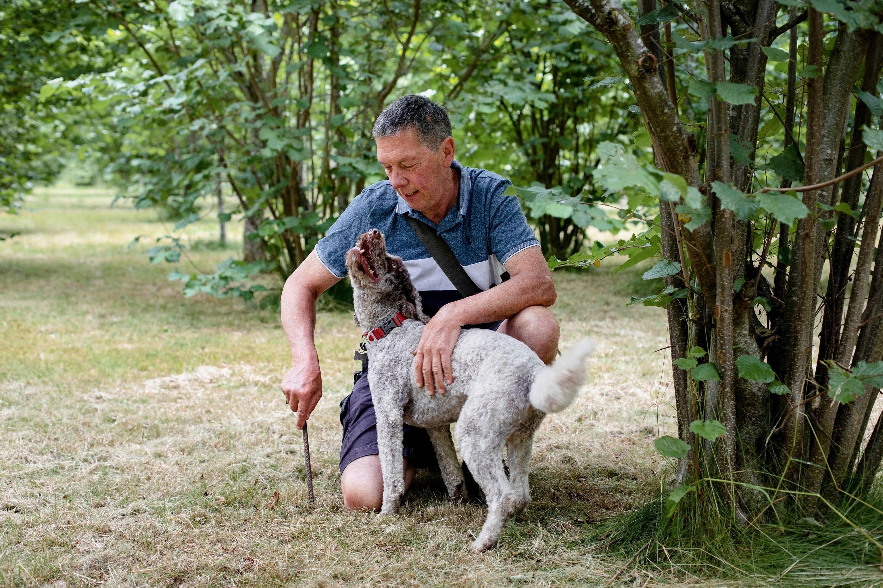 Mike and his dog, Oscar, in the orchard.