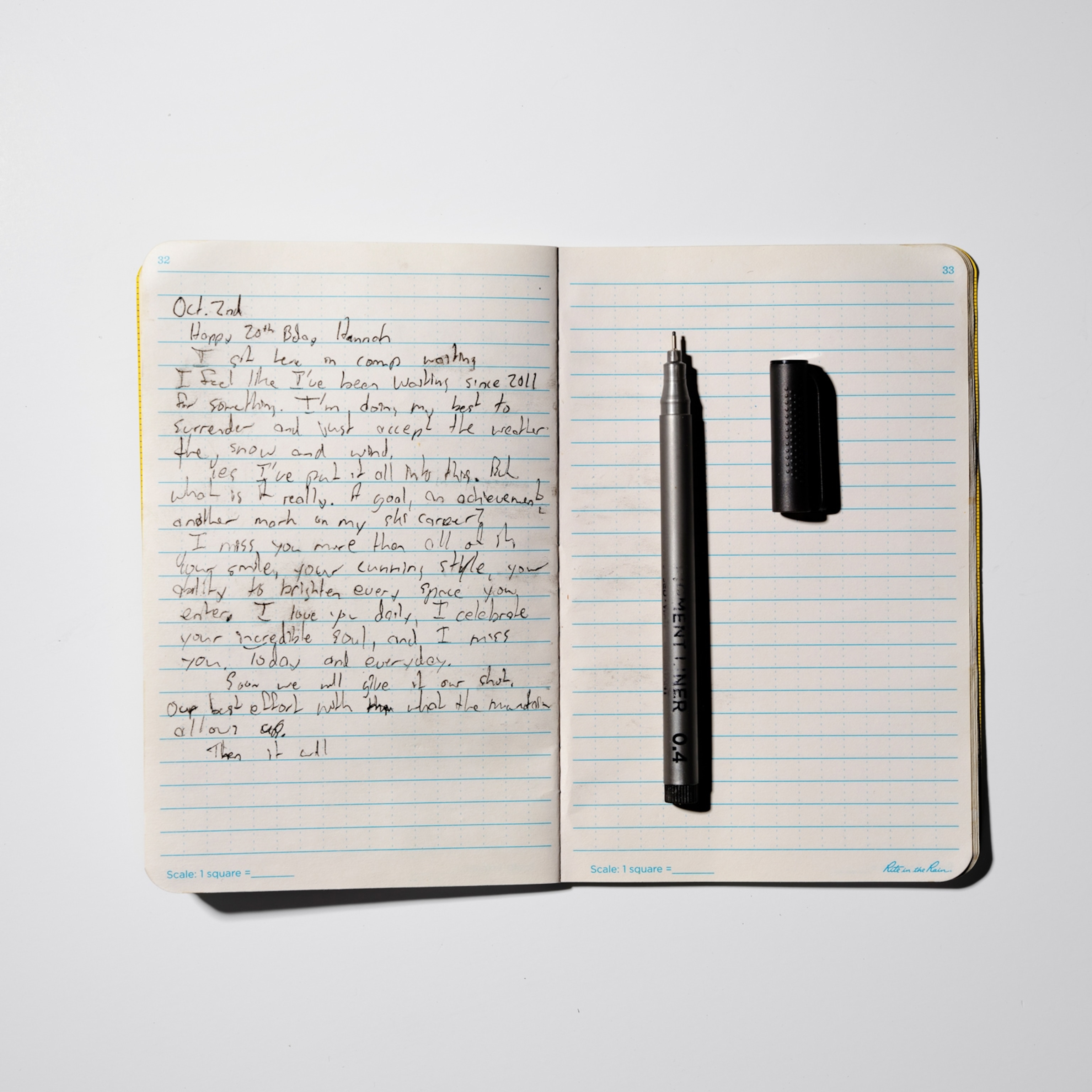 An open lined notebook lies on a white surface. The left page contains a handwritten journal entry dated “Oct 3rd,” while a black fine-tip pen and its cap rest vertically on the otherwise blank right page.