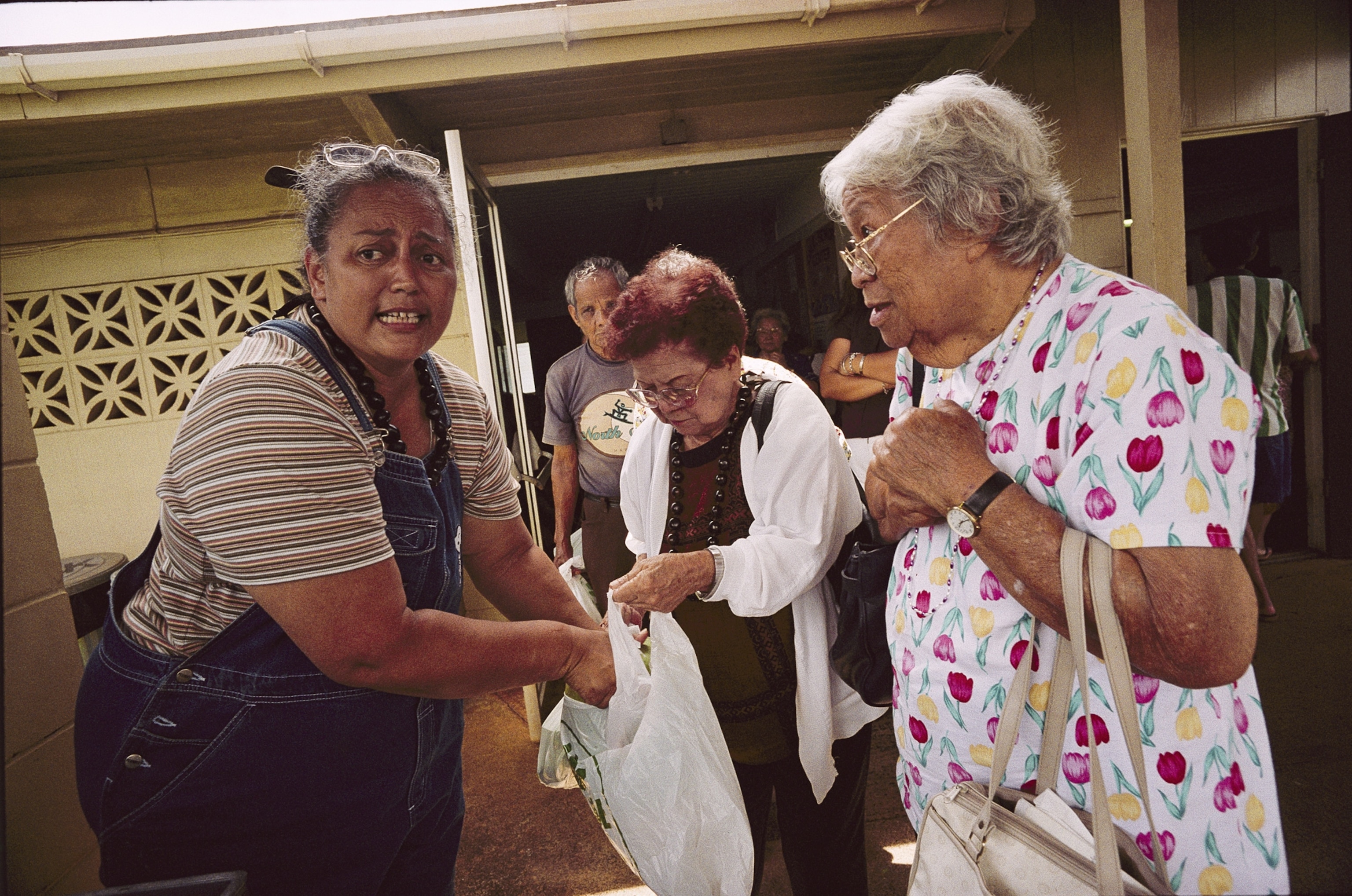 a man transporting his daughter in a stroller on a busy road to a shelter in Houston, TX.
