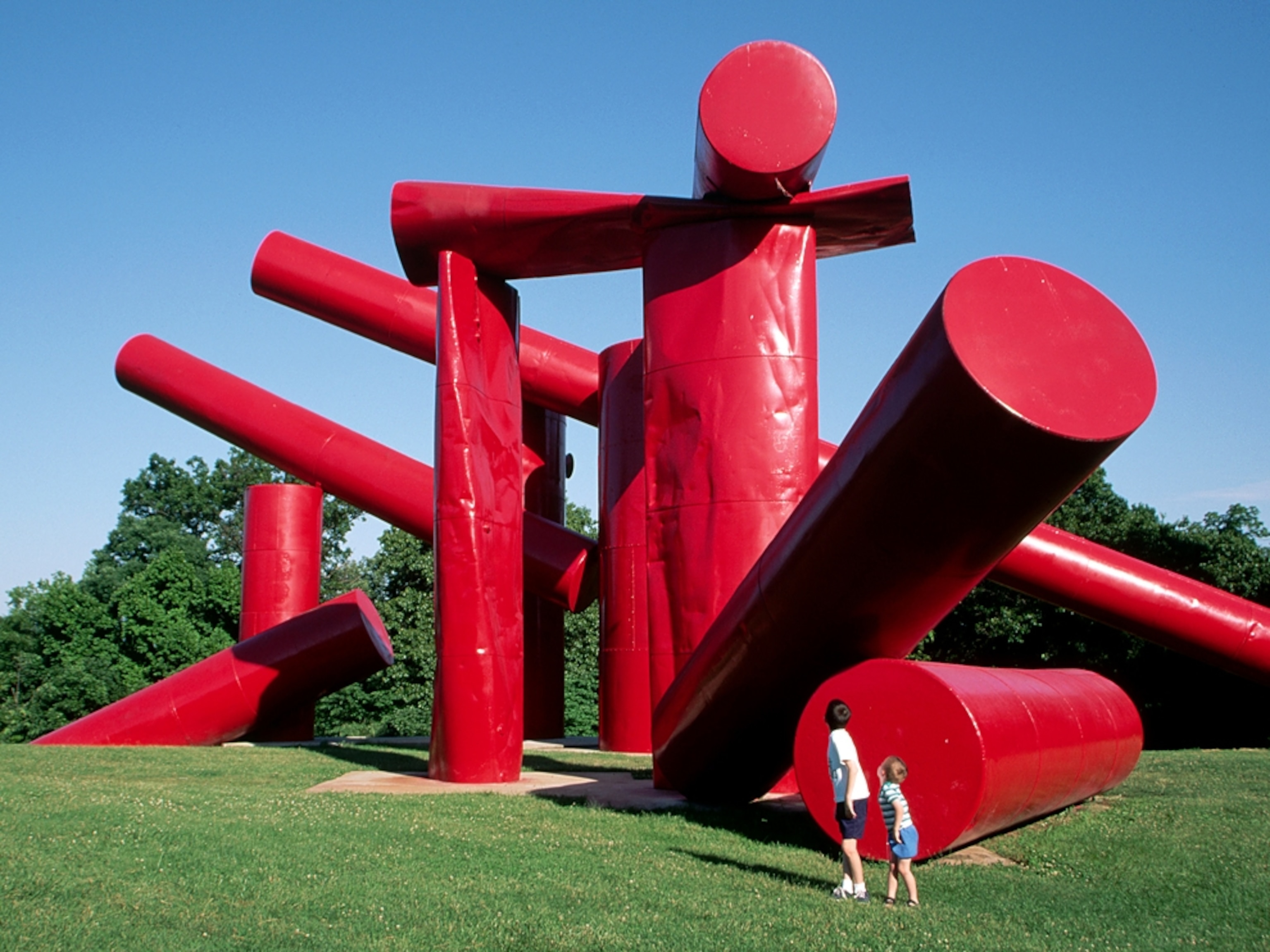 children playing around a red sculpture