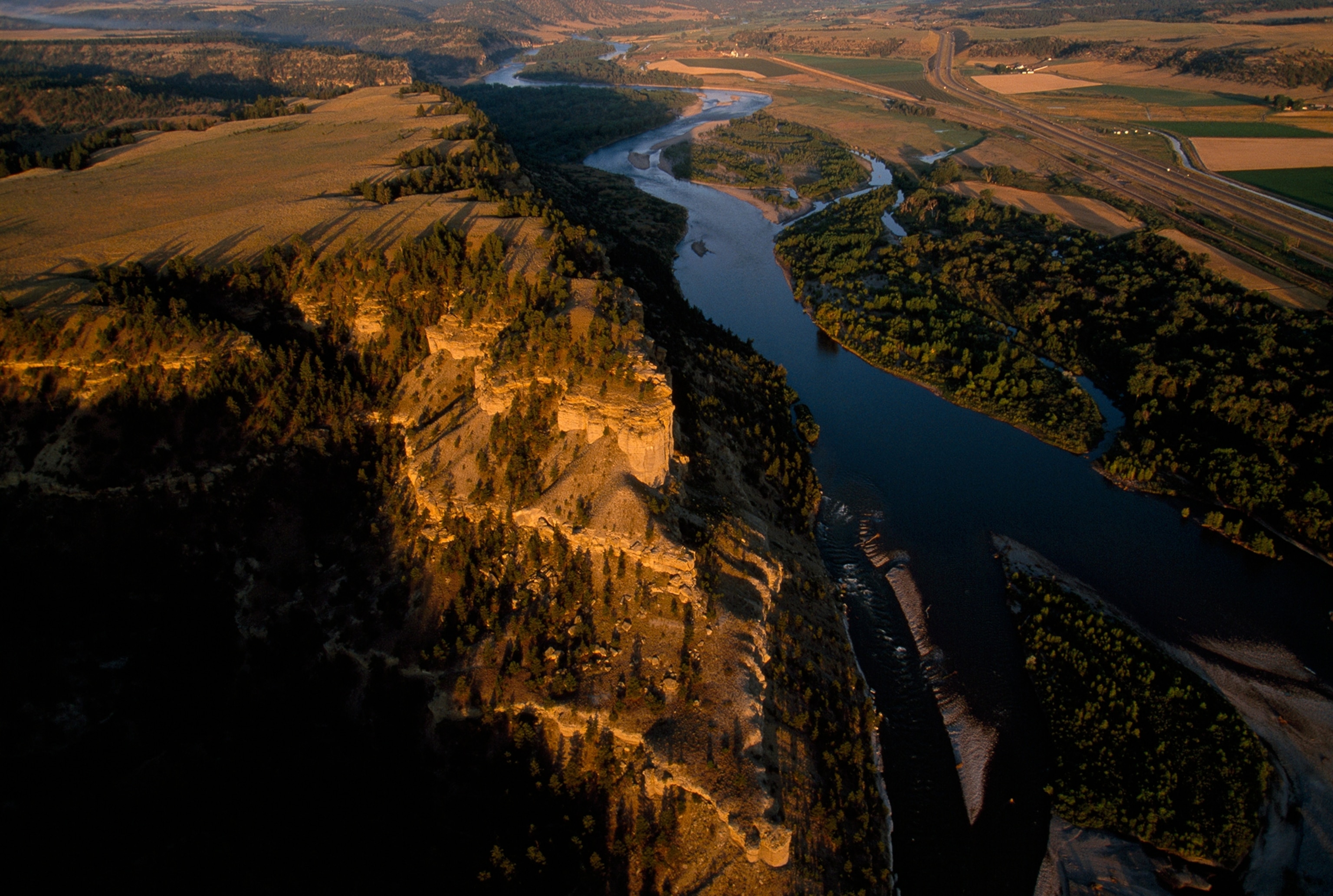 cleanup workers cutting holes into the ice on the Yellowstone River near Crane, Montana