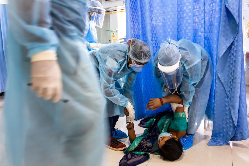 Medical staff attend to woman who fainted.