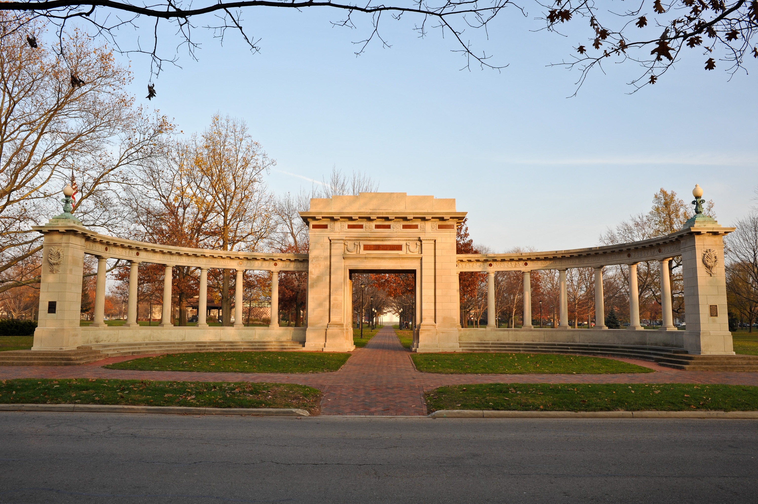A white curved structure with columns at sunrise