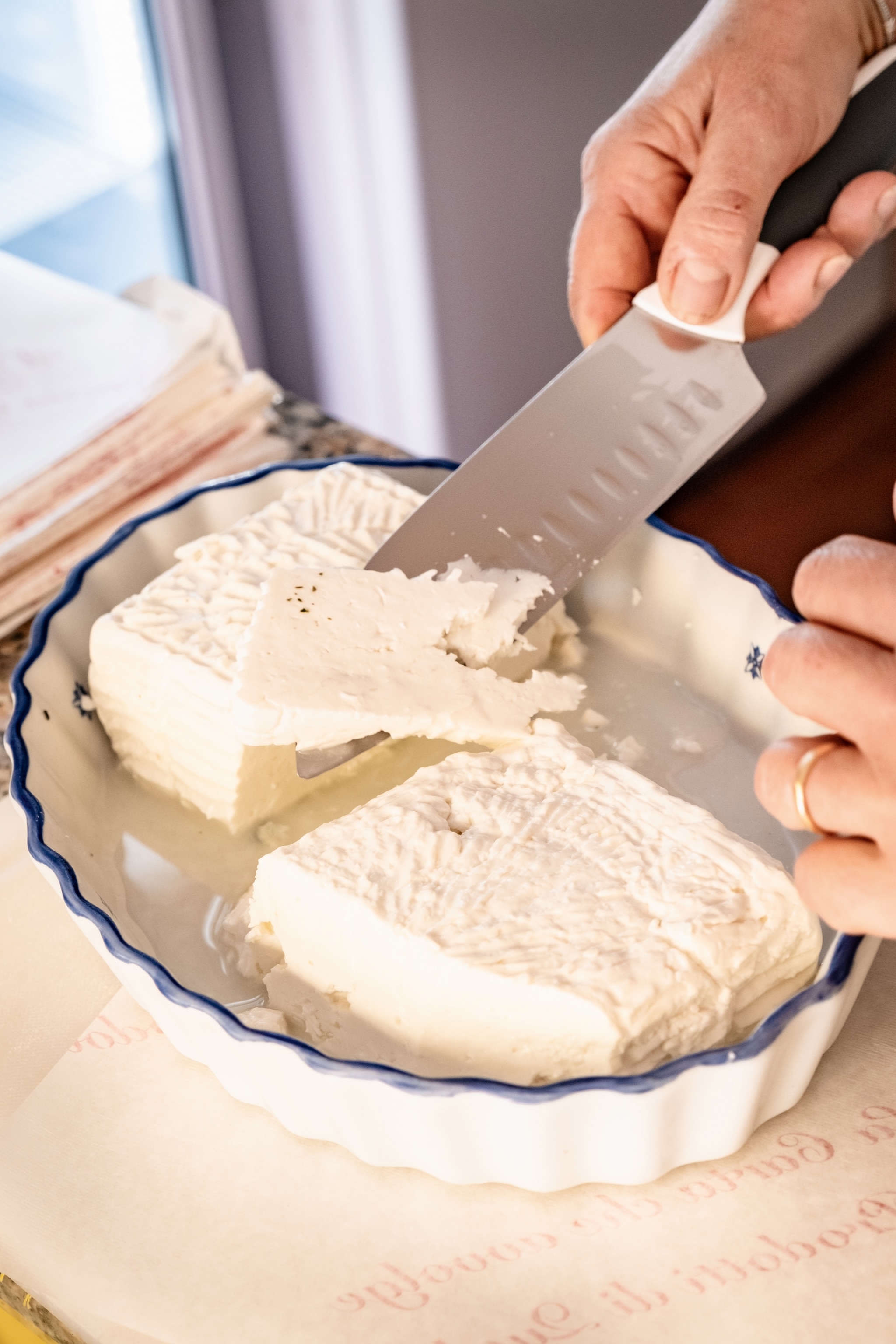 Knife slices soft white cheese