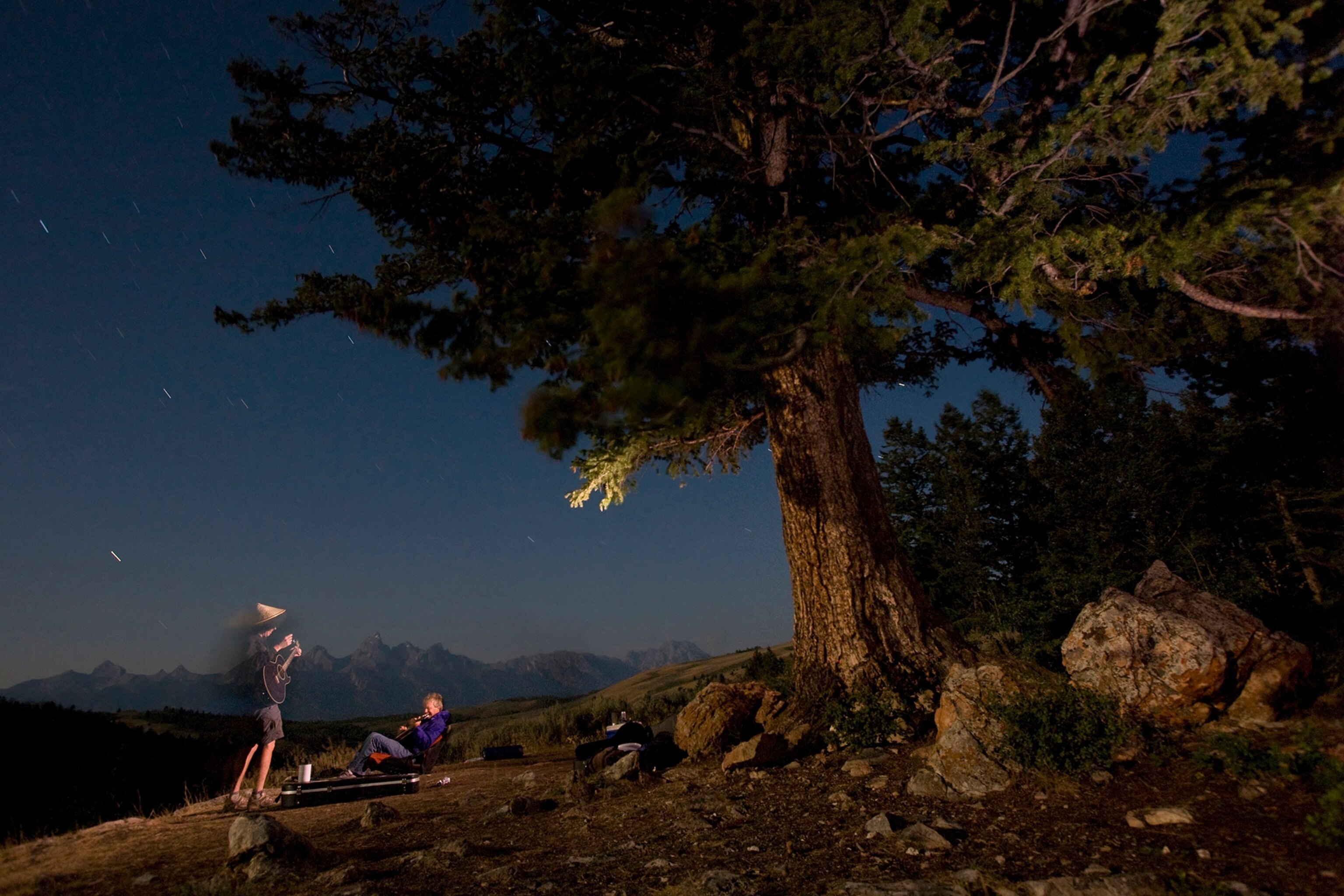 two hikers playing guitar in Grand Teton National Park, Wyoming