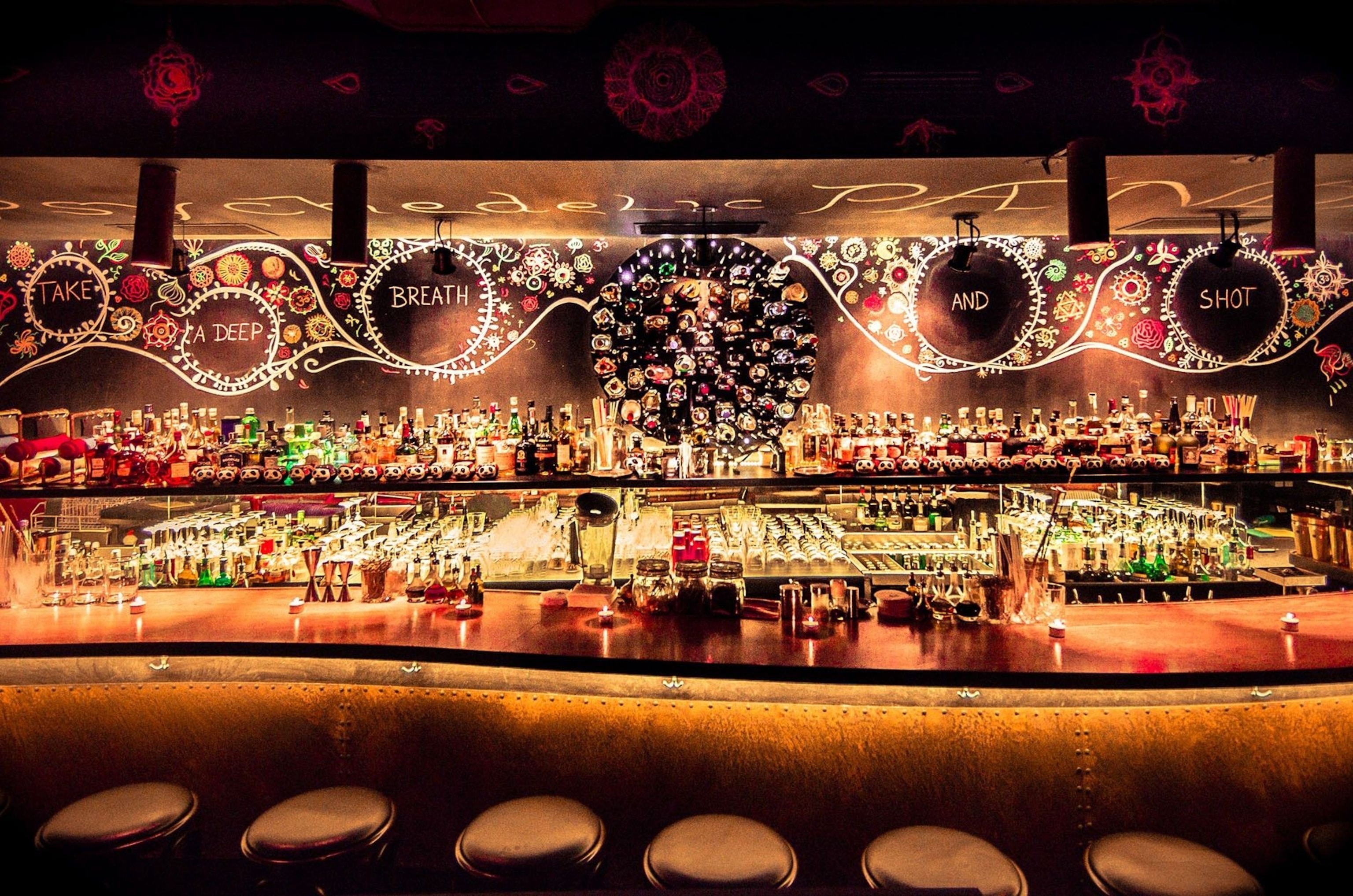 The low-lit bar of the cocktail bar Super Panda Circus, Brno, where bartenders challenge guests to a game to determine their order.