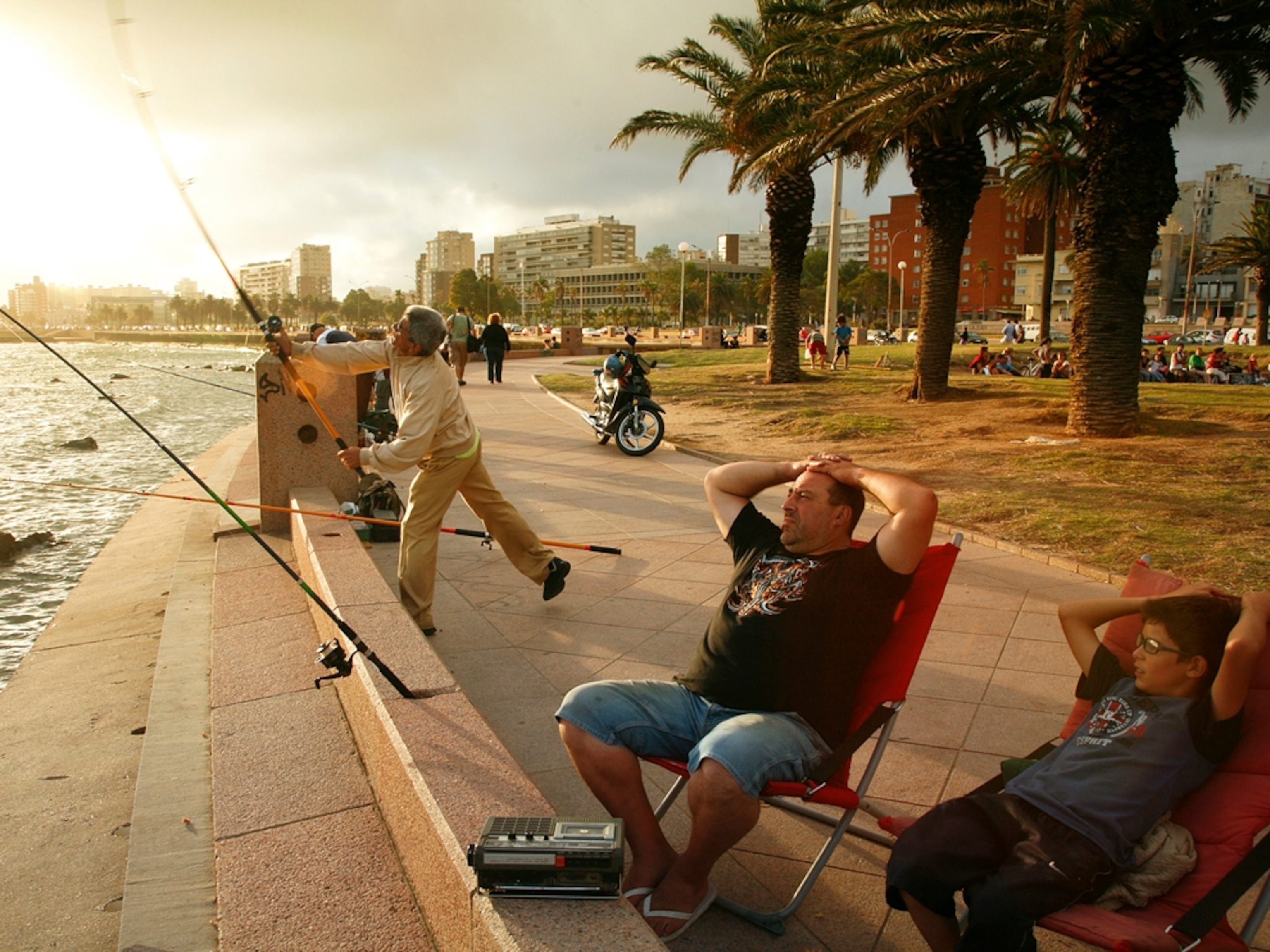 people fishing and walking along the Rambla