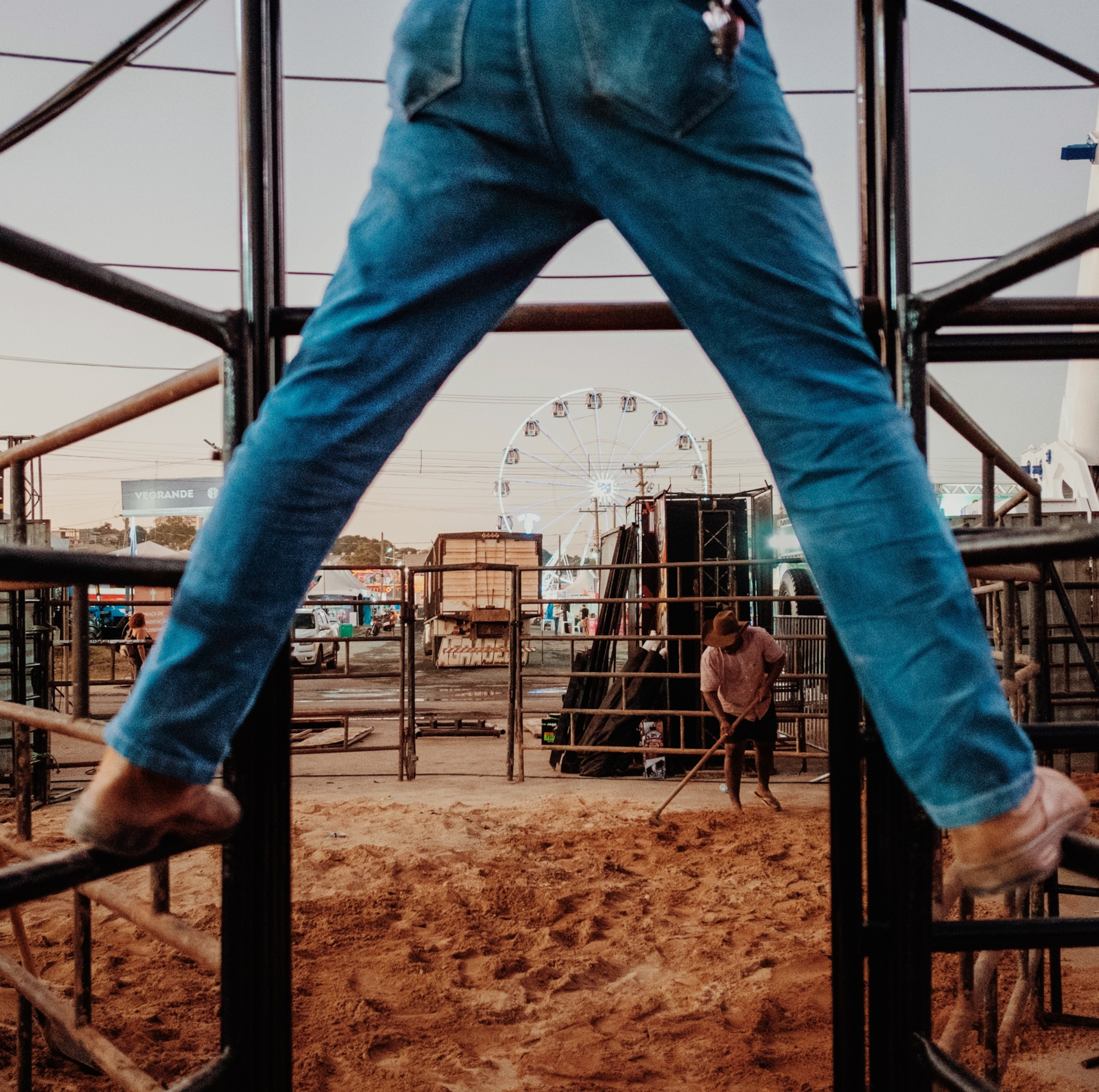 A rodeo workers tending to a holding pen.
