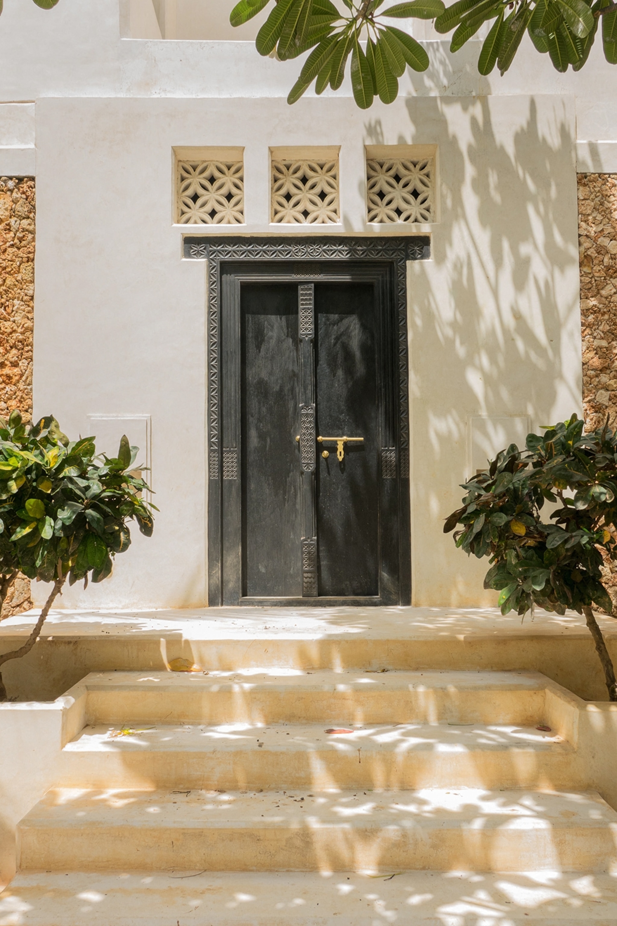 The entrance to a Swahili mansion with a carved double door.