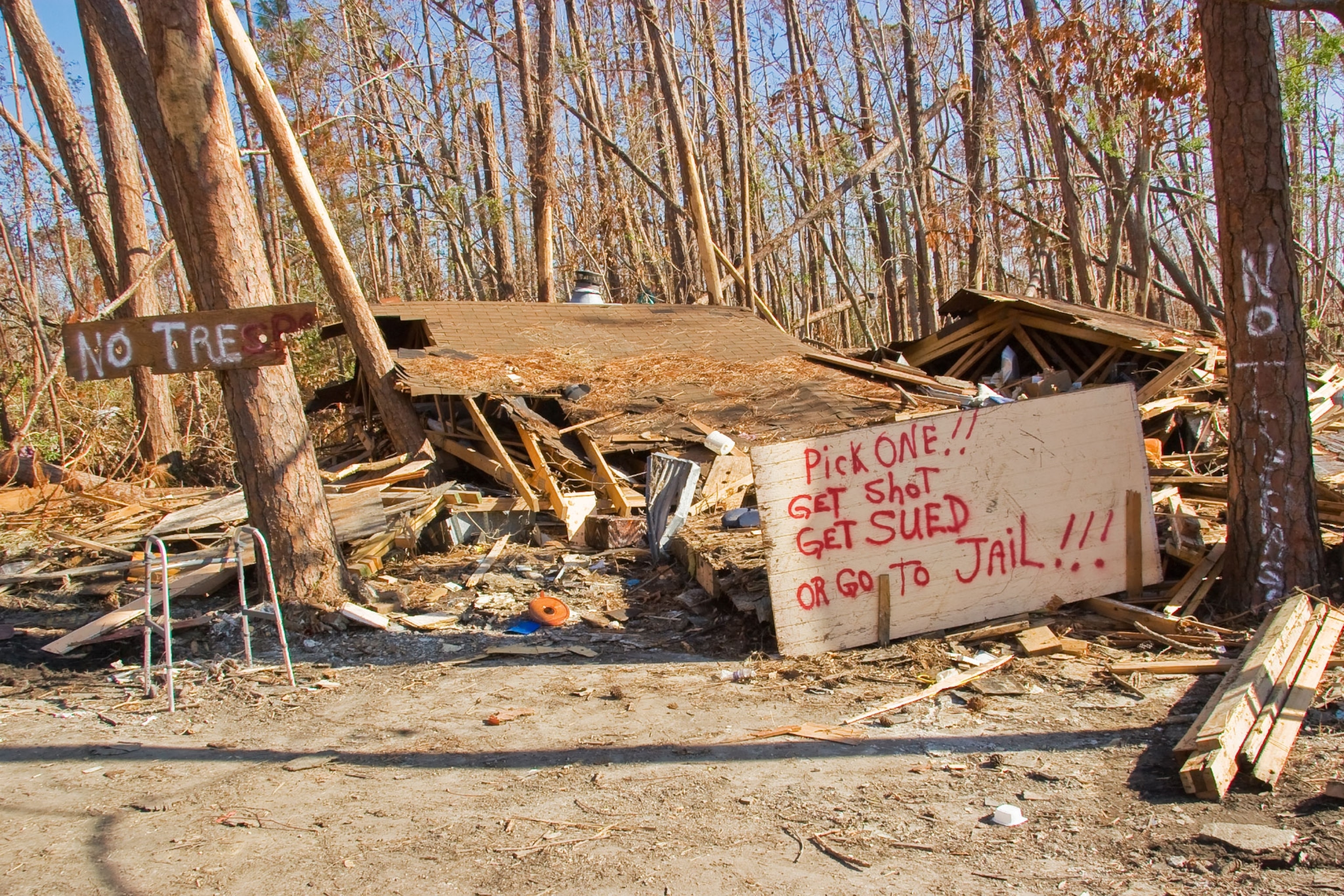 destroyed home and warning signs in Mississippi after Katrina