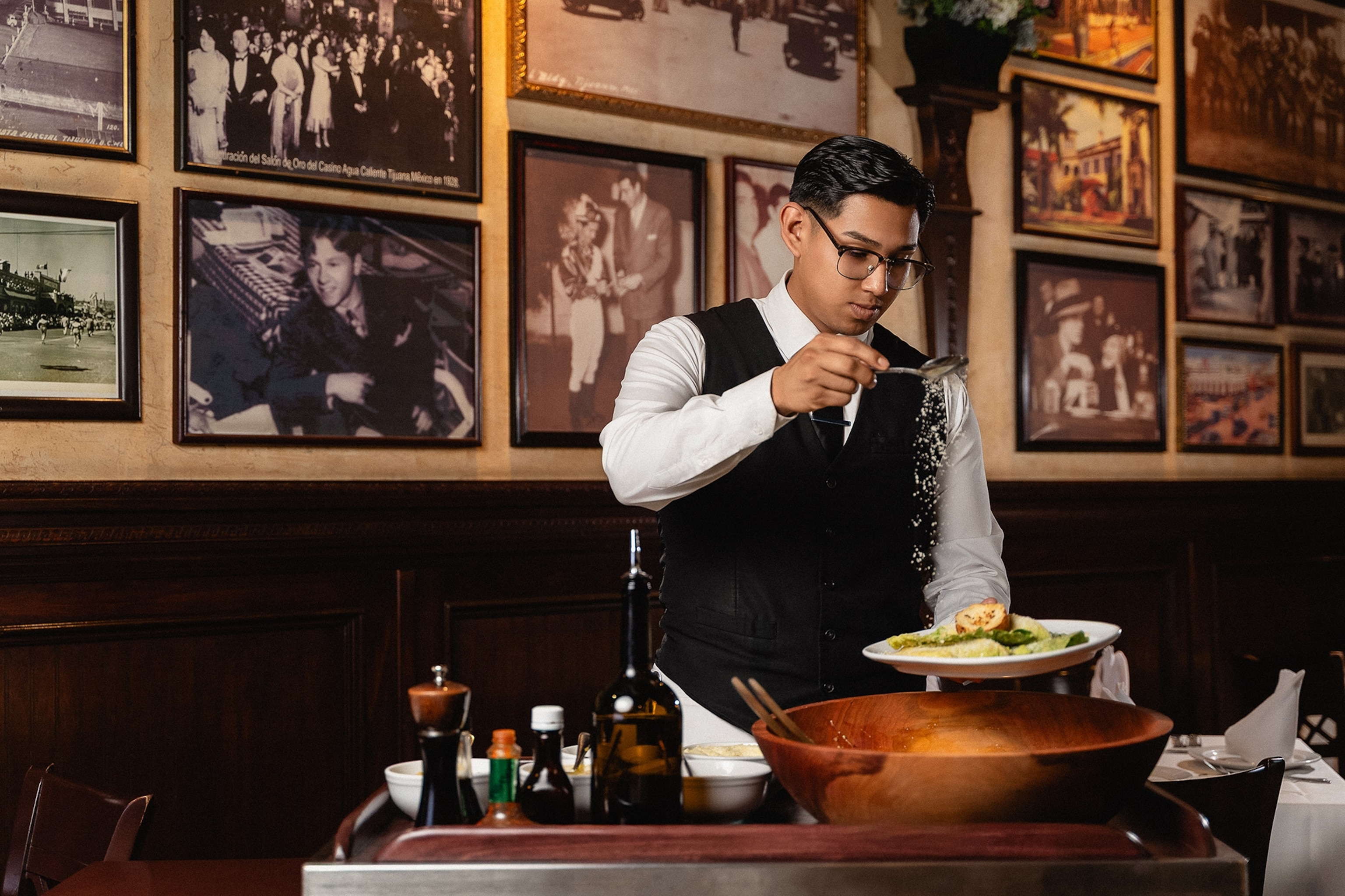 a server at Restaurante Caesar's makes a tableside caesar salad