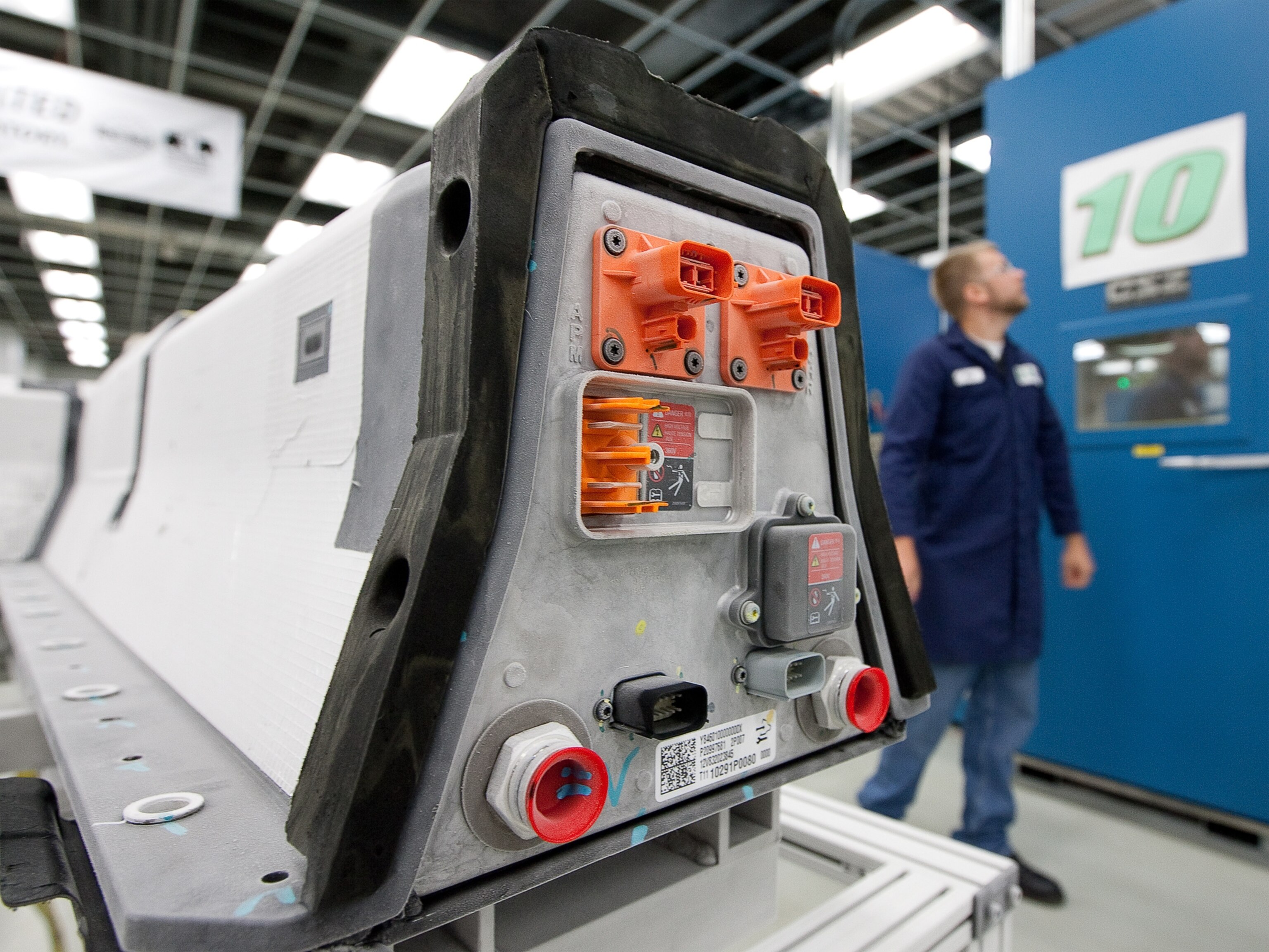 picture - a GM engineer examining a climate test chamber