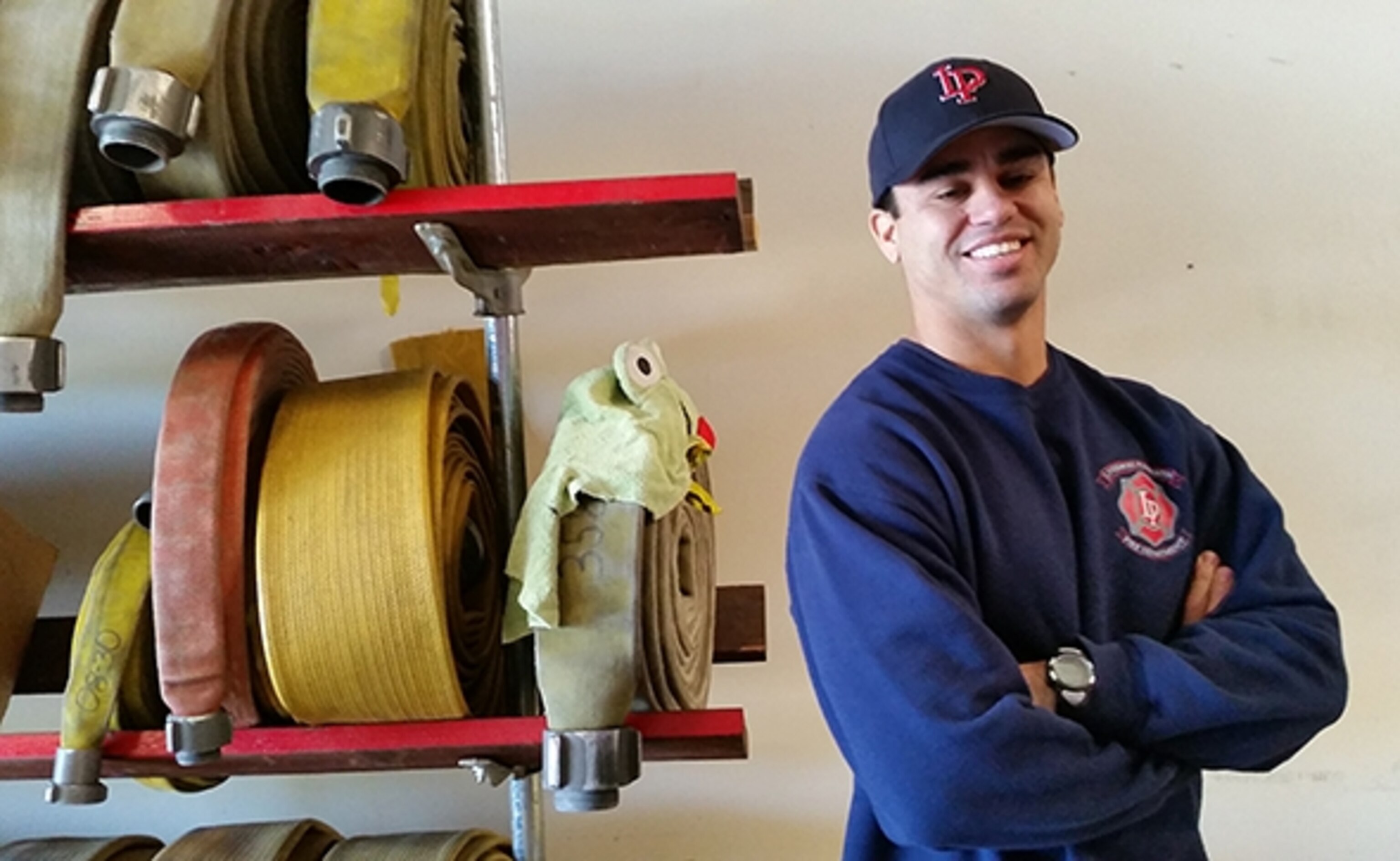 Gilbert the fireman and a firehose with a frog hat (Photograph by Robert Reid)