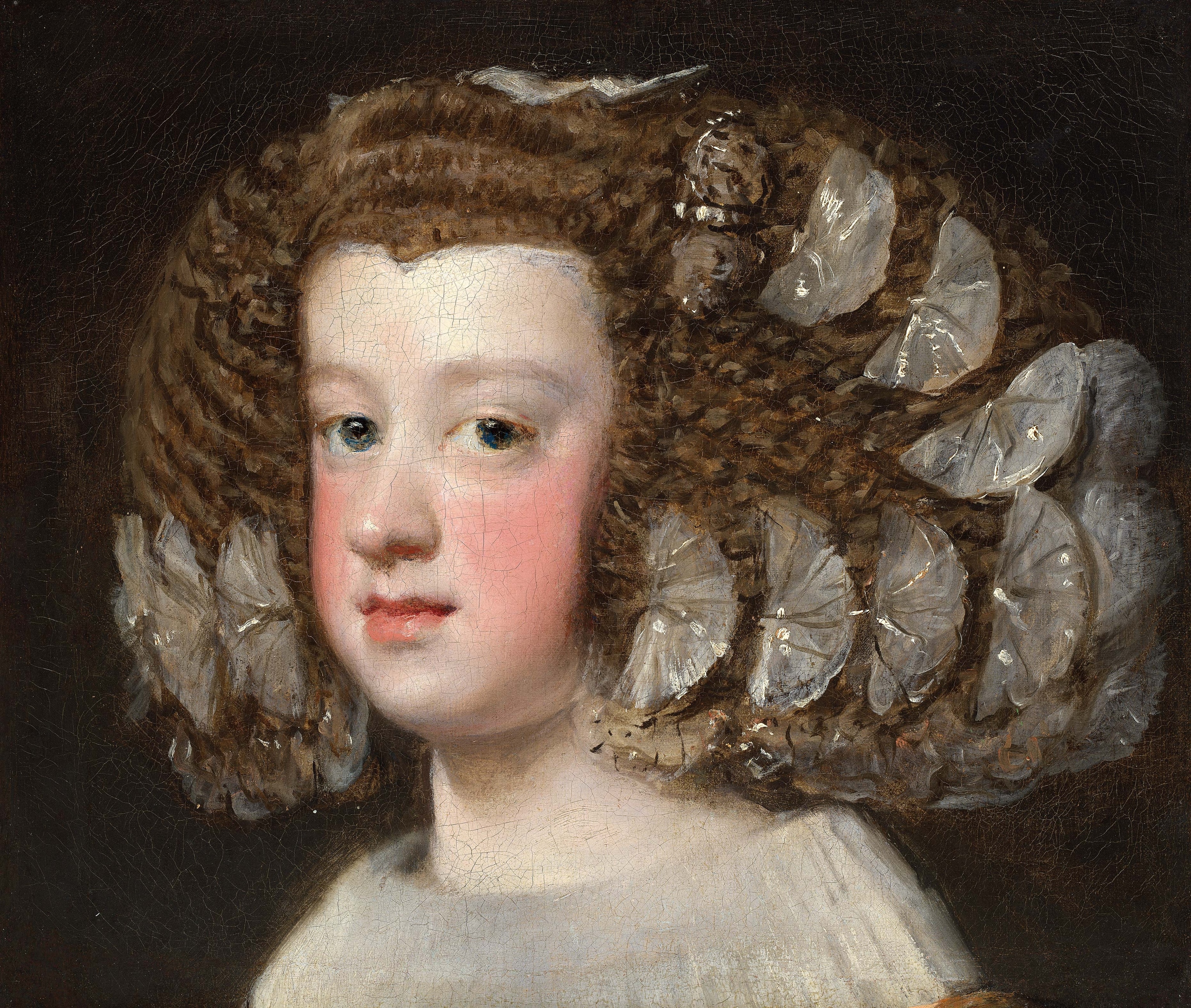 A side profile of a woman with large hair and special white pieces in it