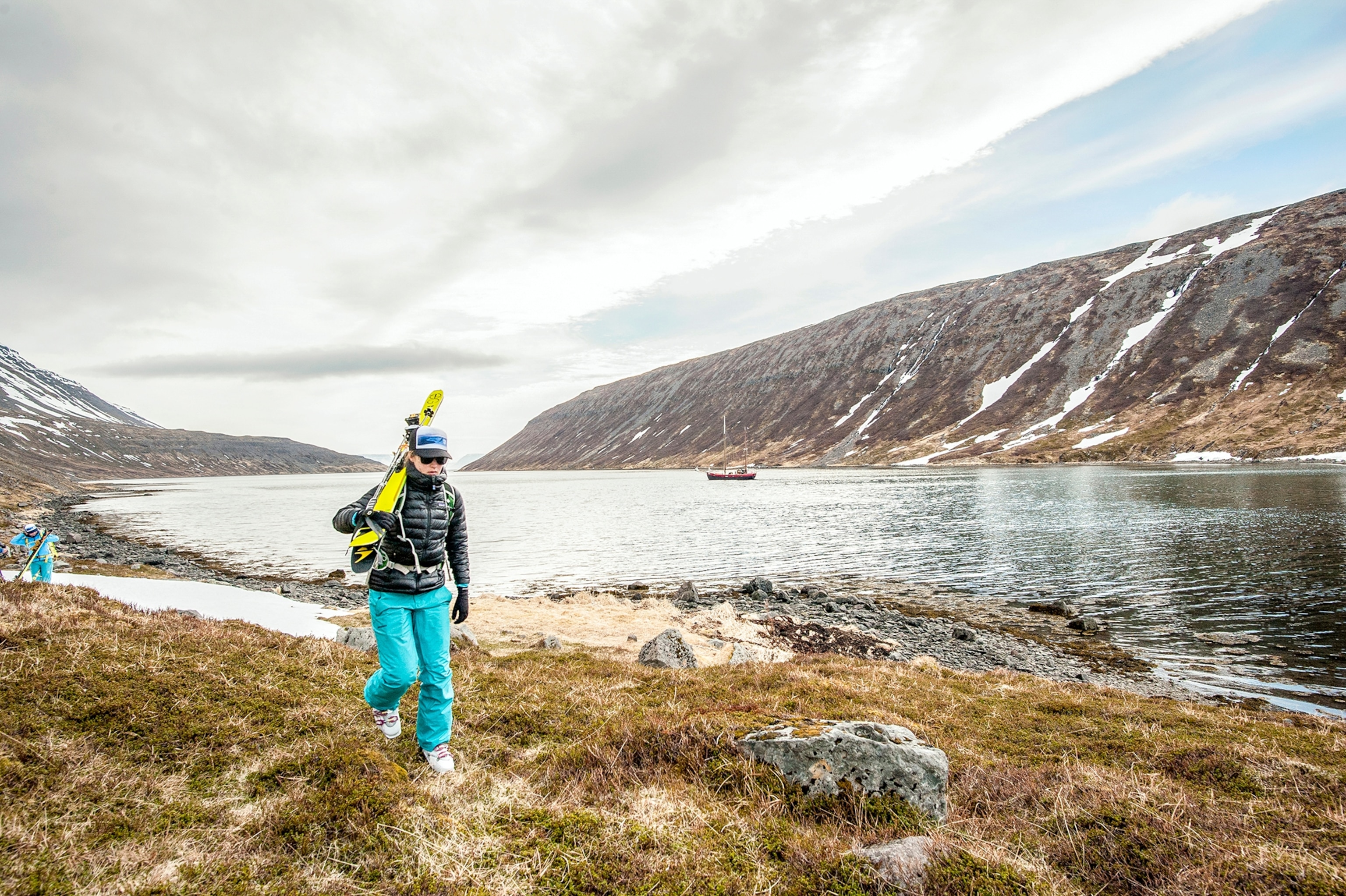 a group of skiers hiking up a hill in Iceland
