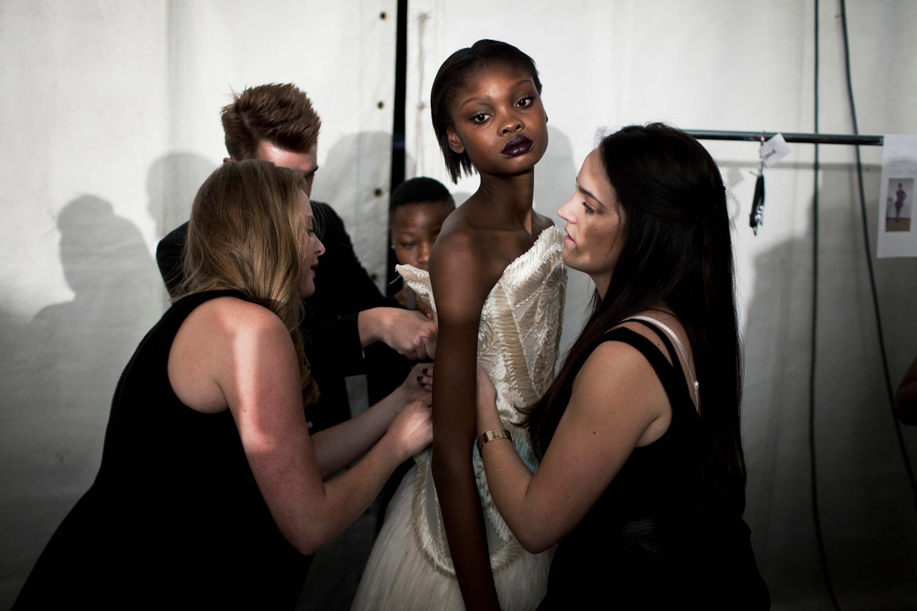 Favour Lucky, a 15-year-old Nigerian model, gets dressed backstage during Mercedes Benz Africa Fashion Week in Johannesburg, South Africa. Lucky won Nigeria’s next supermodel contest when she was 14 years old.