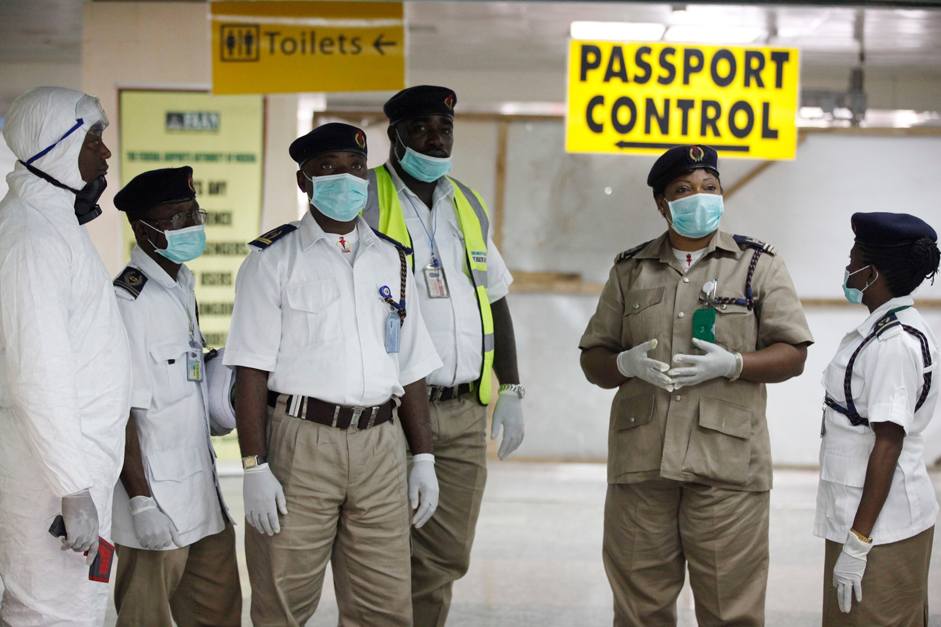 Dr. Steven Hatch checks his protective gear in a mirror before entering a high-risk ward at an Ebola clinic run by the International Medical Corps near in Suakoko, Liberia, Oct. 13, 2014.