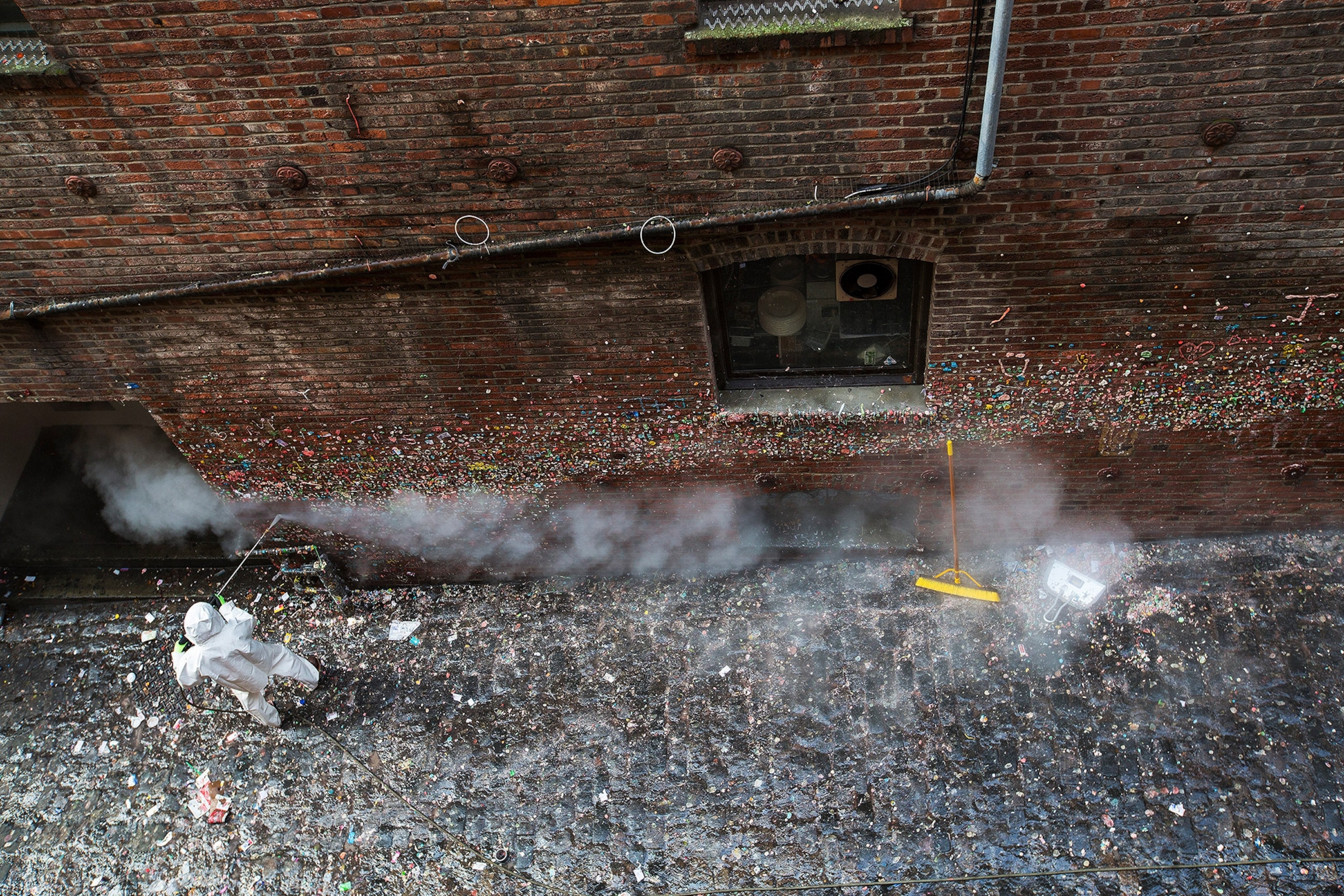 a person working on cleaning gum off the gum wall in downtown Seattle, Washington