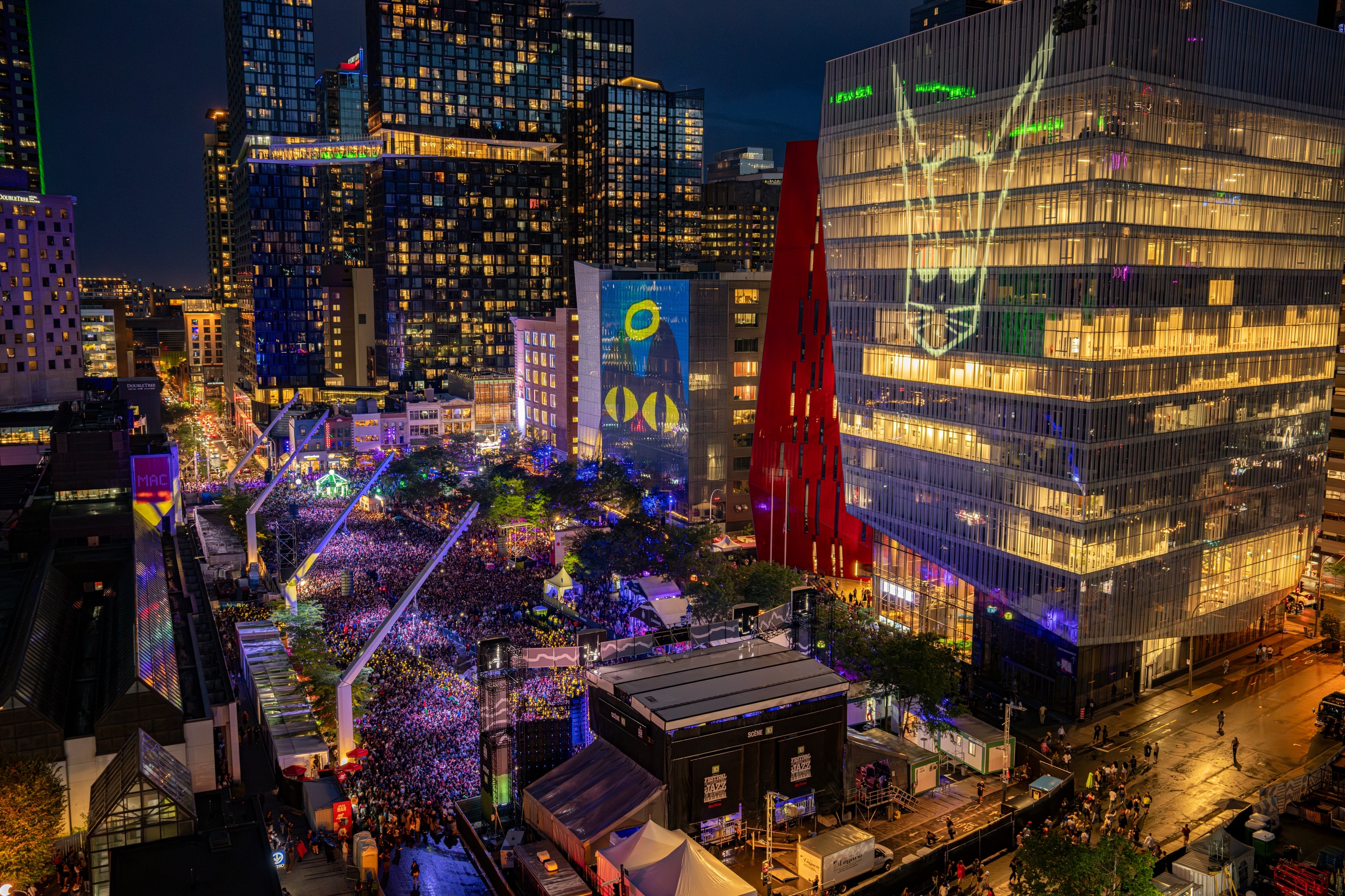 View of the Montreal Jazz Festival's main stage with projections of the 45th edition poster featuring the festival's mascot: Ste-Cat the cat.