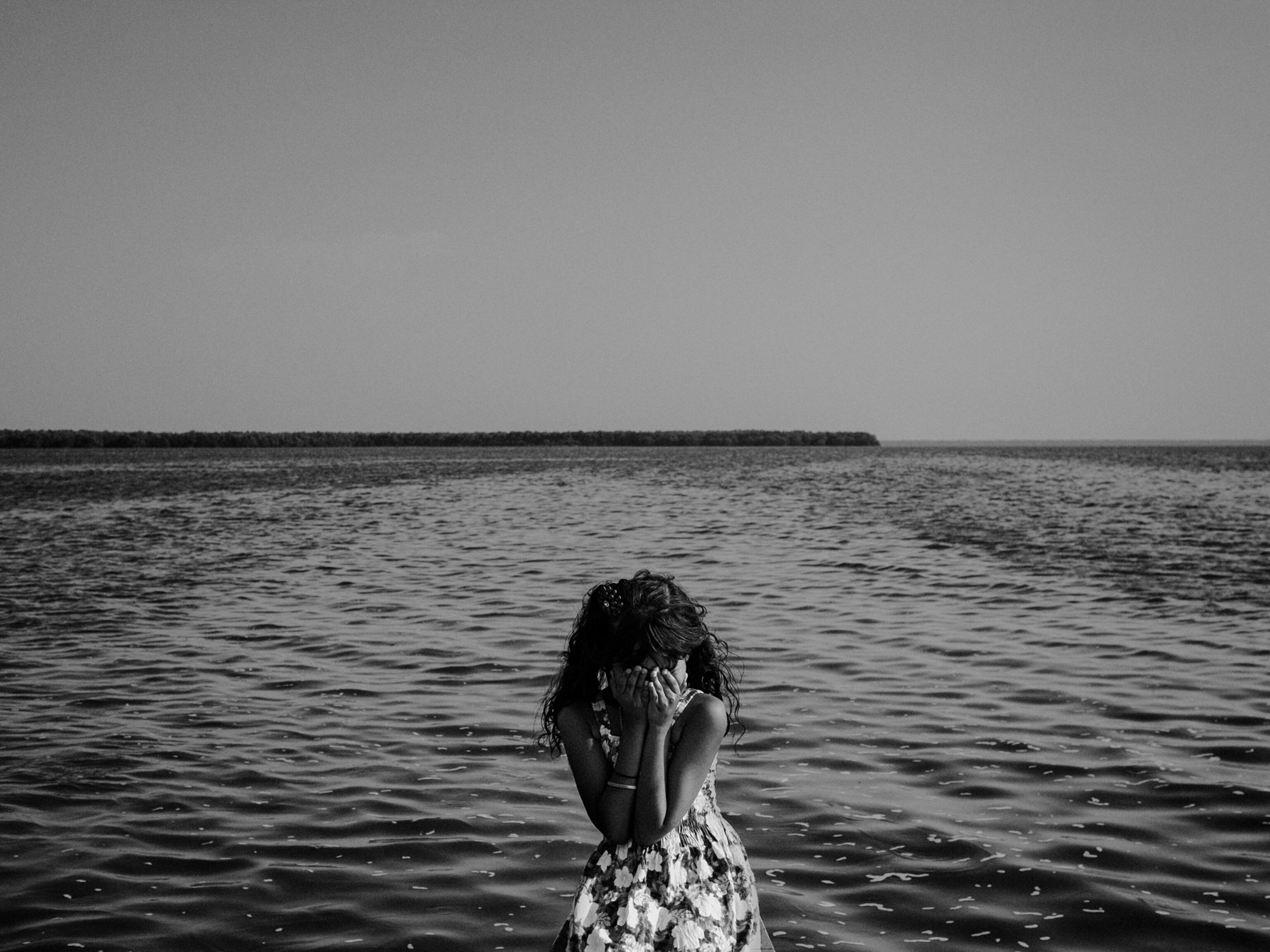 a young girl standing near the river in Nueva Venecia, Colombia