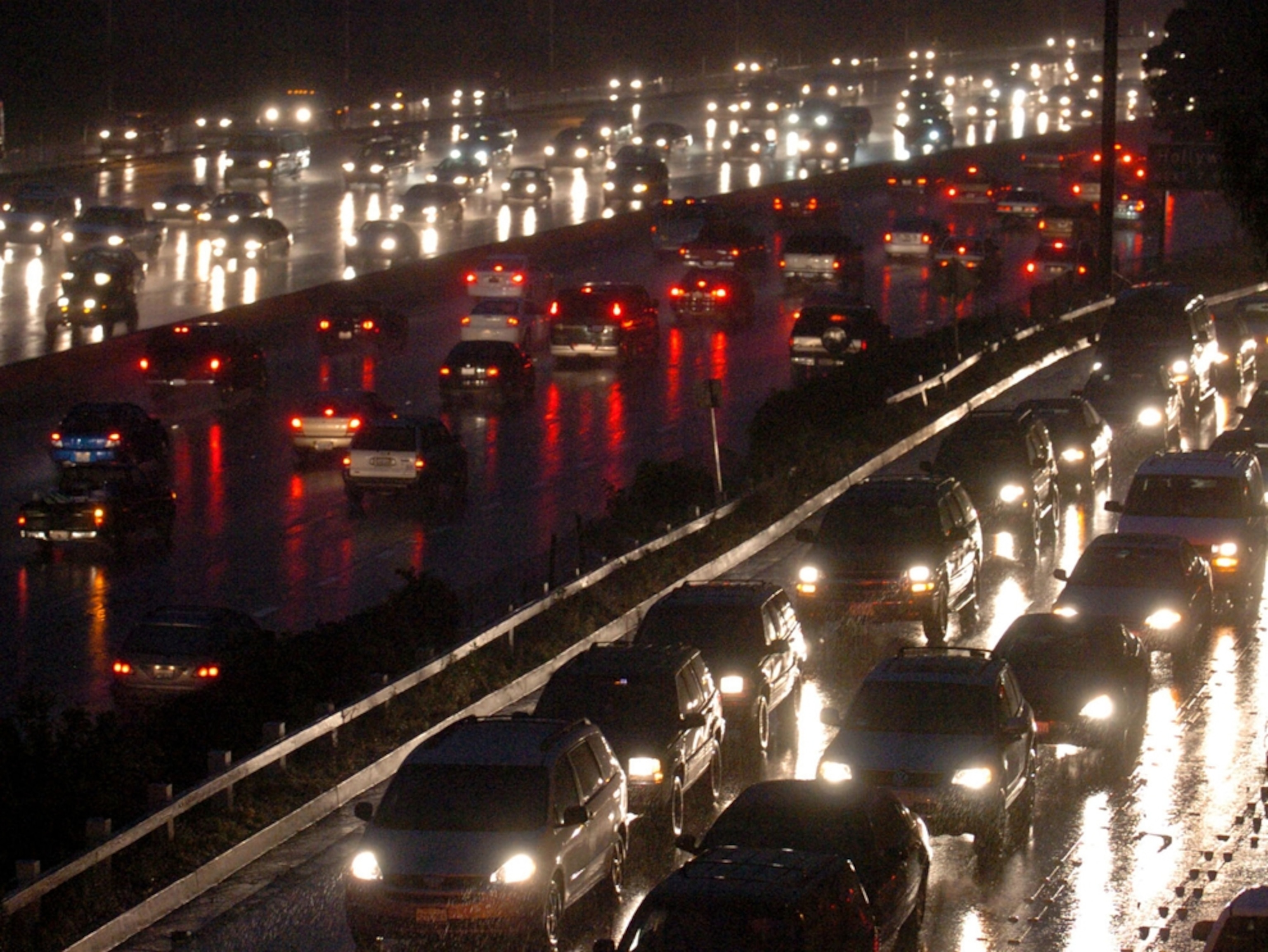 Traffic moves slowly along the 101 freeway through the Cahuenga Pass as new rainfall records are met Tuesday March 22, 2005 in Los Angeles. (AP Photo/Phil McCarten)
