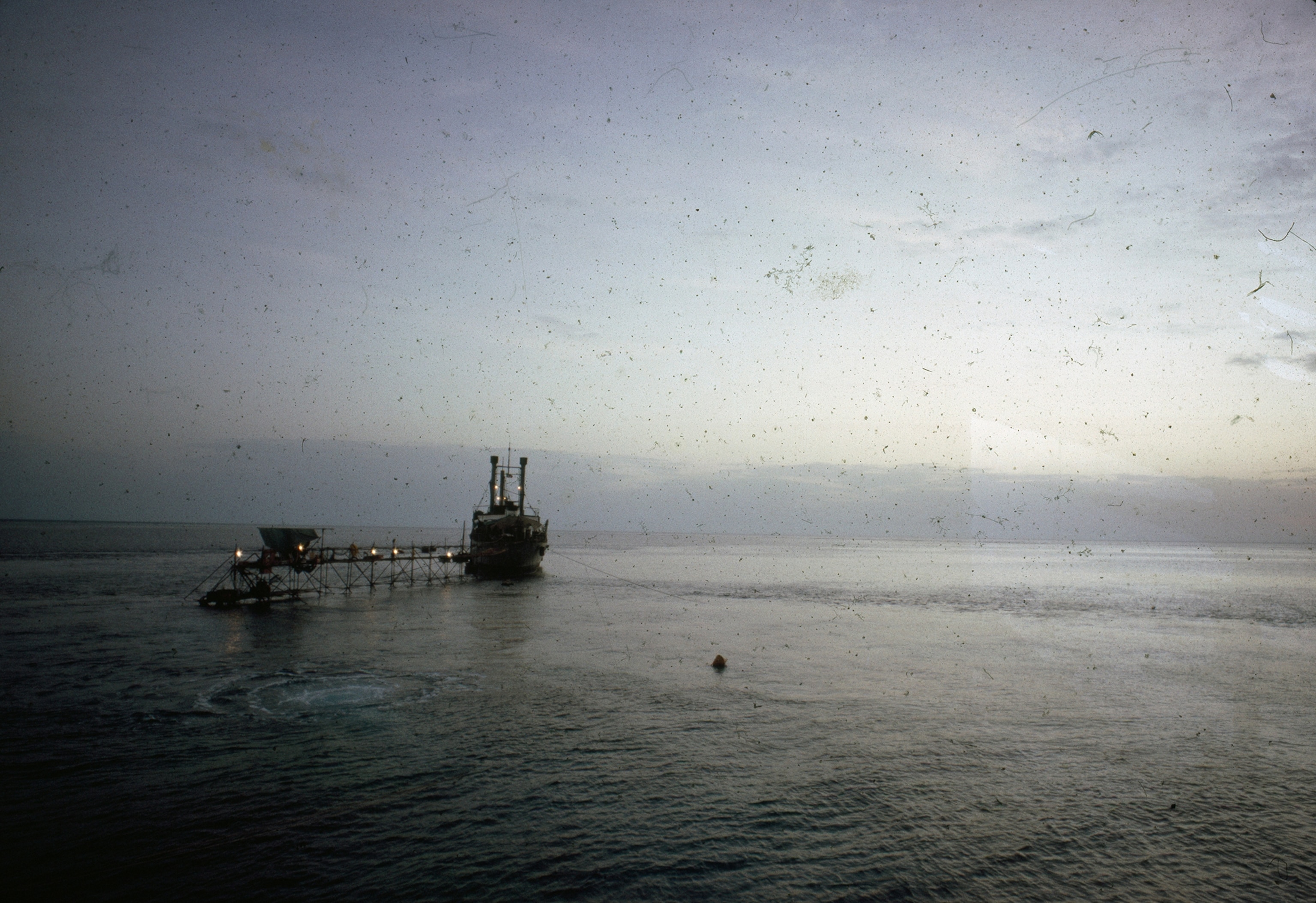 A bridge links a supply ship to an underwater research vessel.