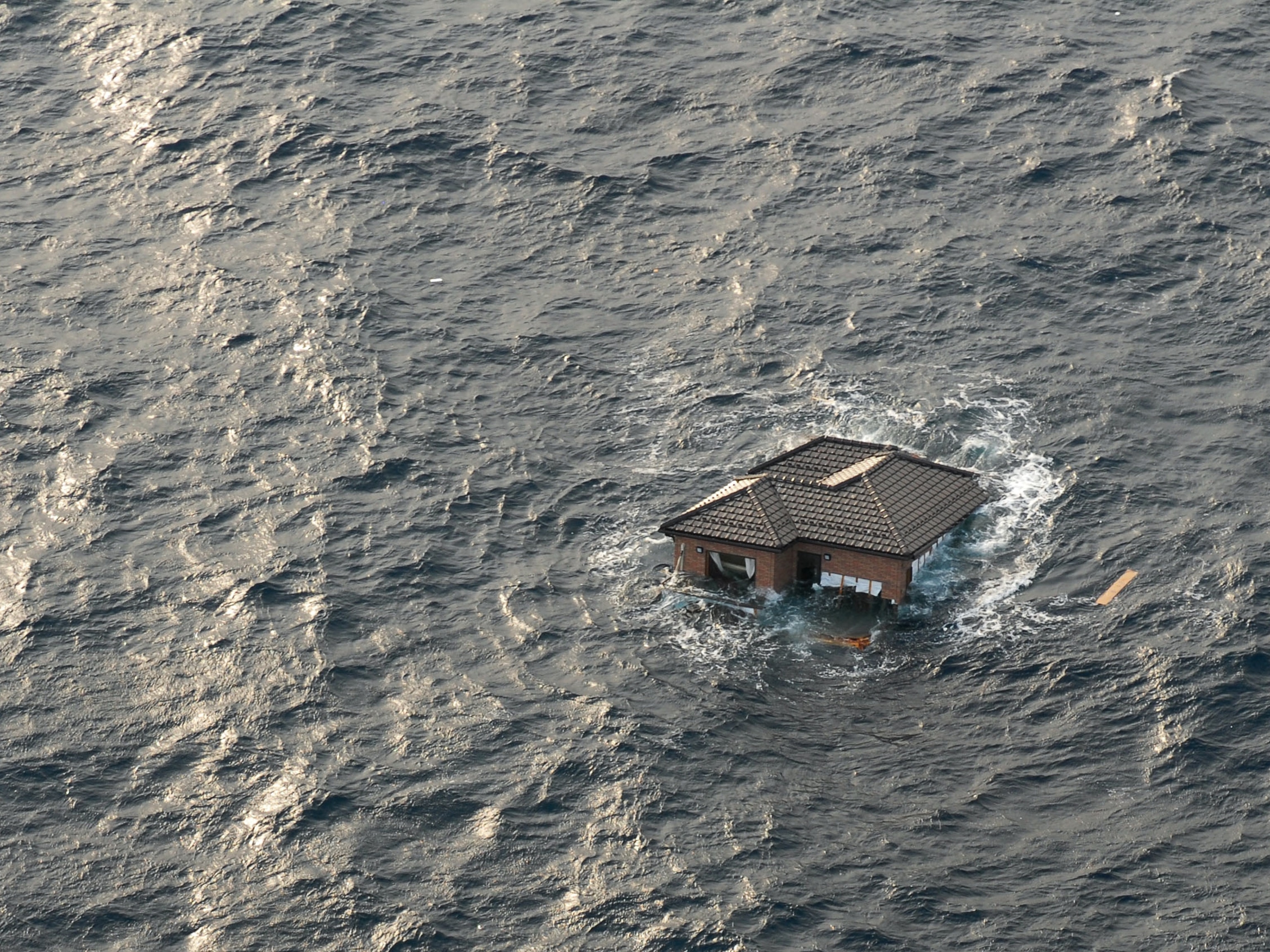 Japan tsunami picture: house floating in Pacific Ocean