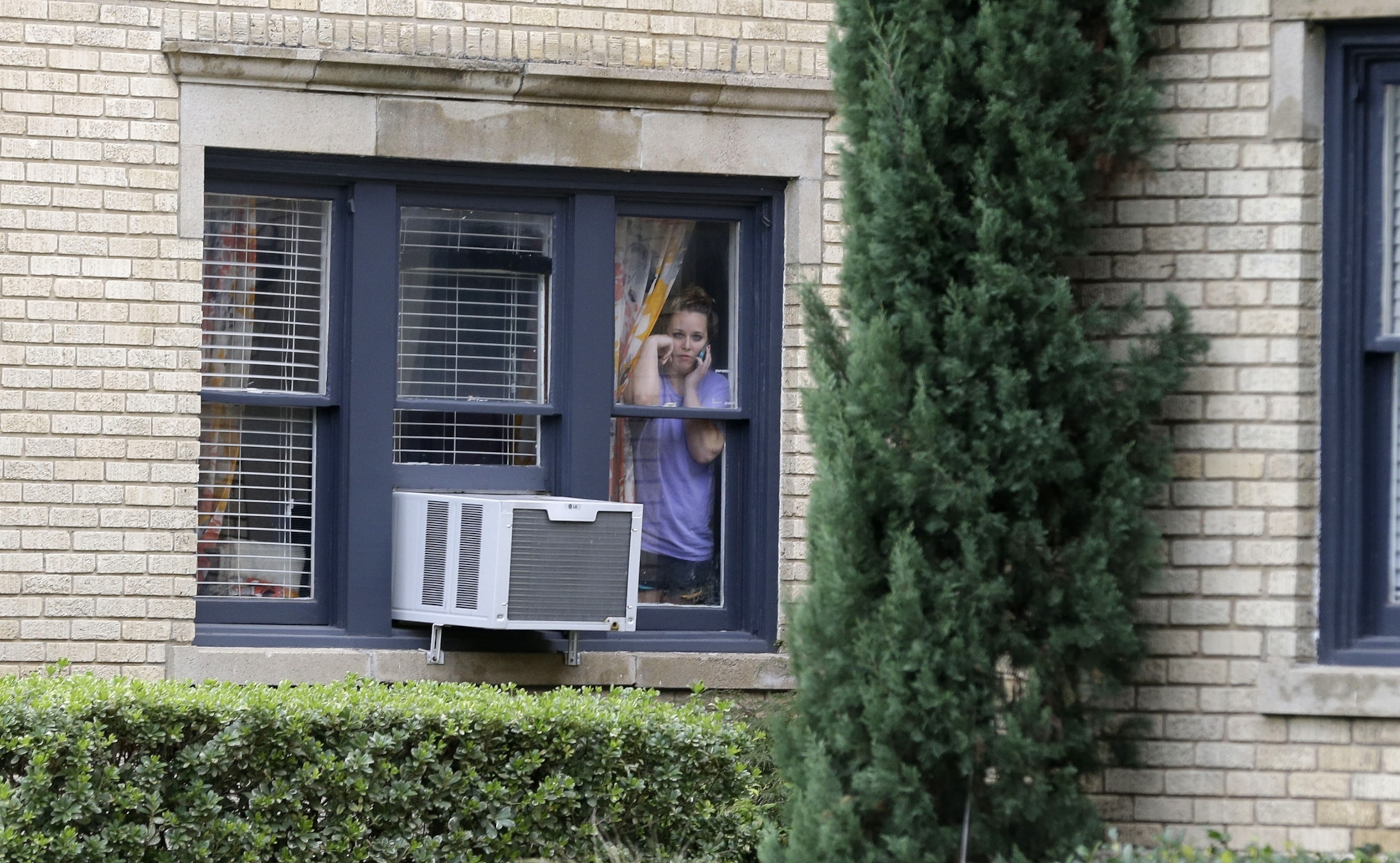 A member of the CG Environmental HazMat team disinfects the entrance to the residence of a health worker at the Texas Health Presbyterian Hospital who has contracted Ebola in Dallas, Texas, October 12, 2014.