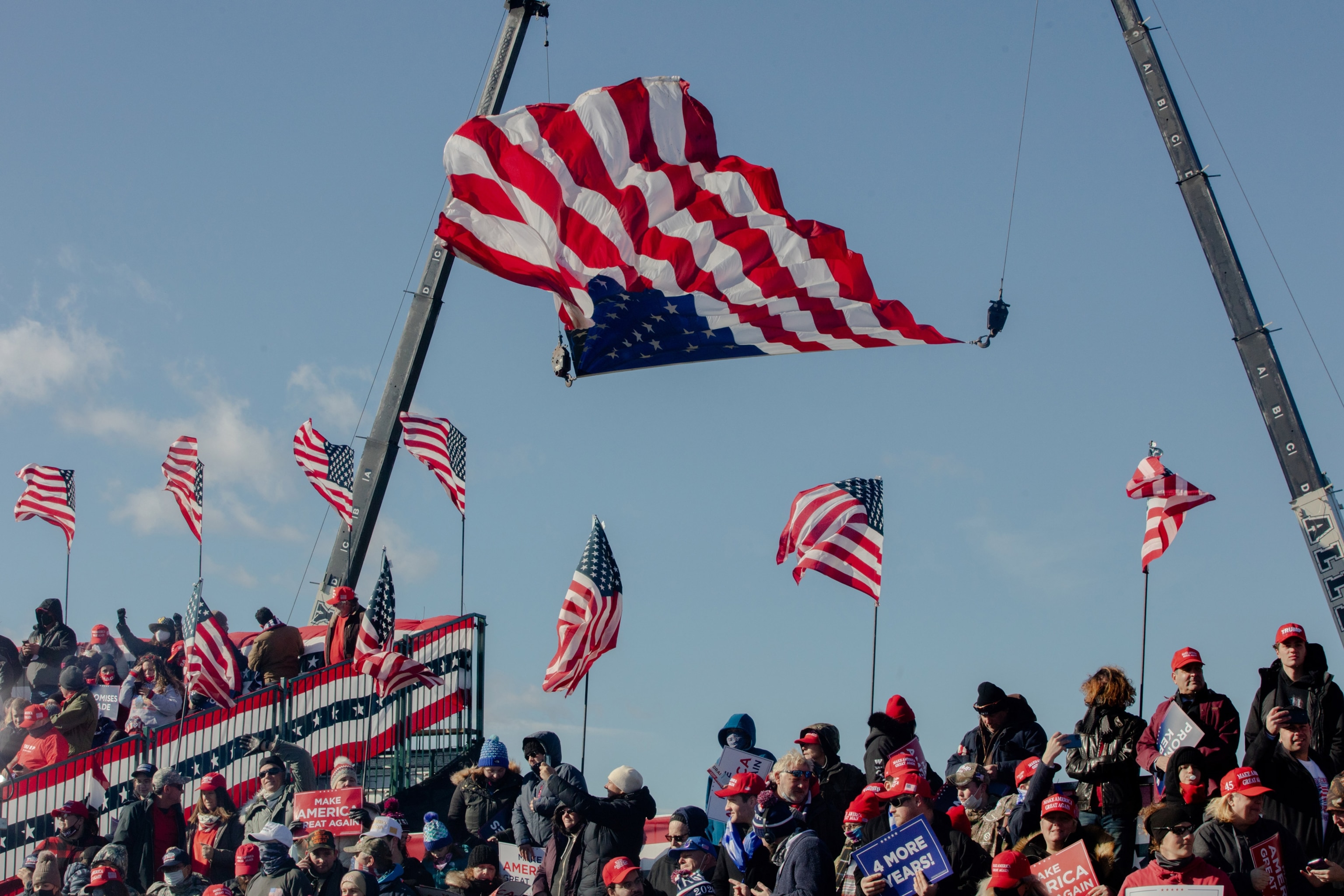 A flag flying upside down above a large crow