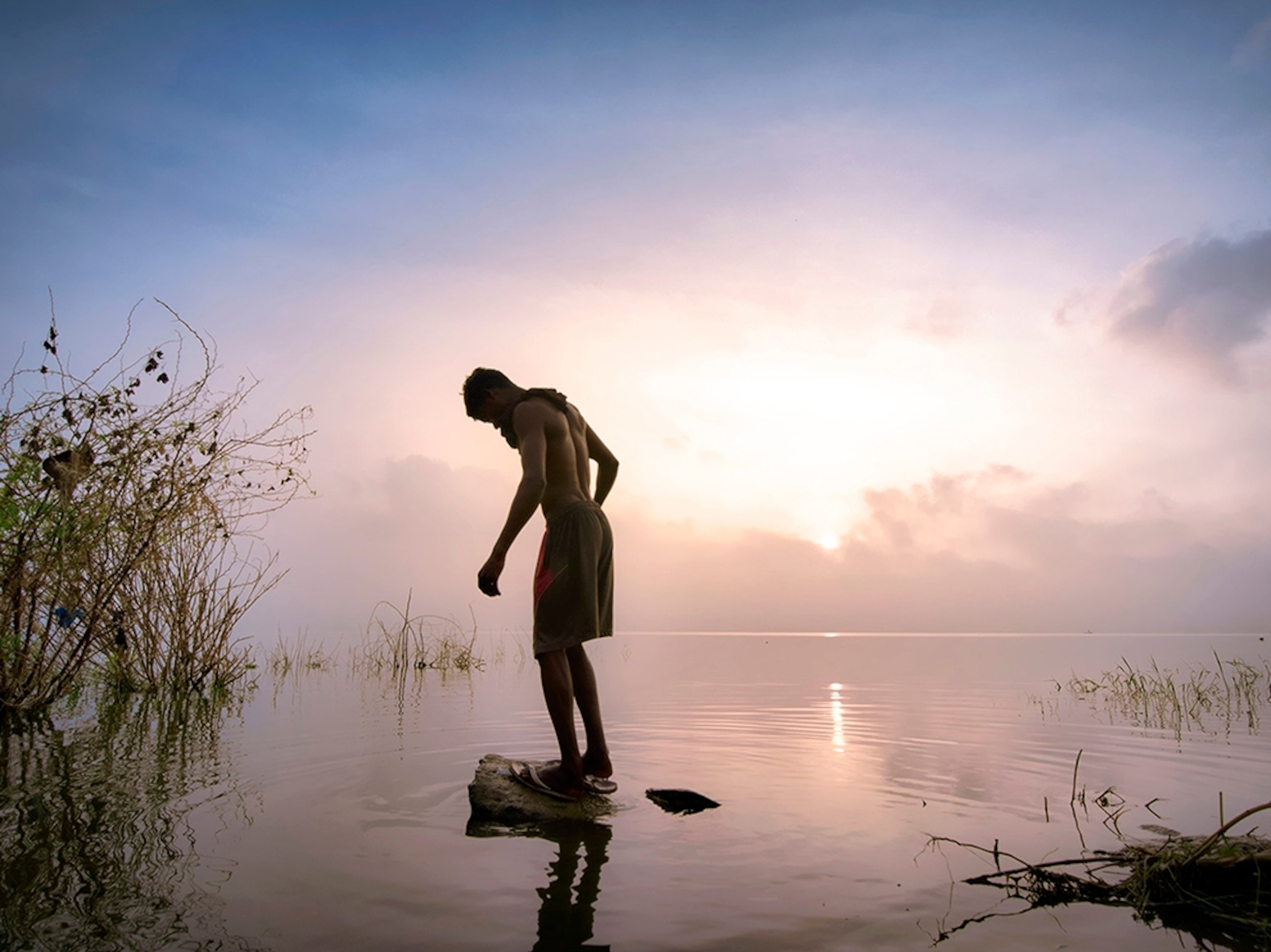 a man standing in a lake in India