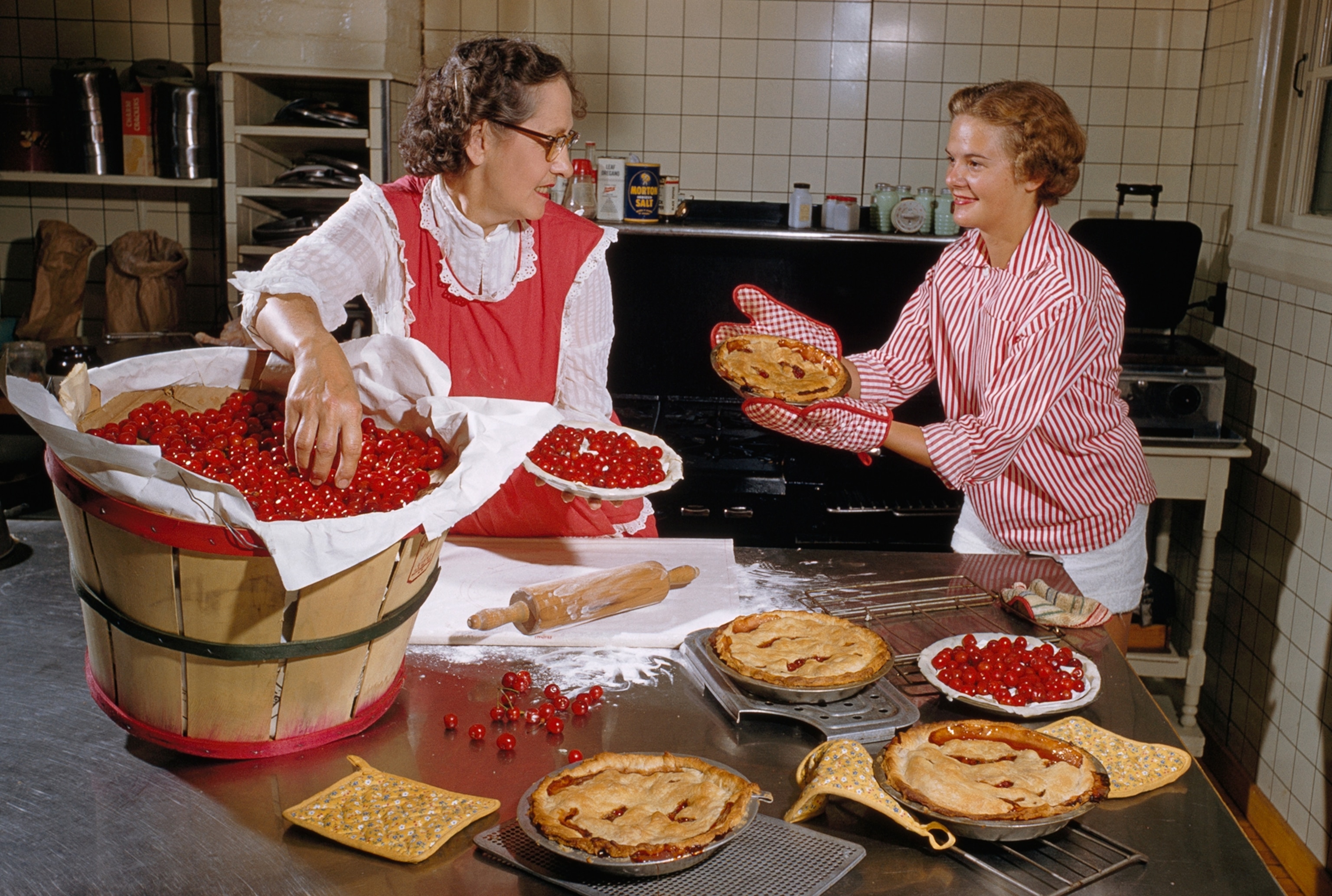 women making cherry pies