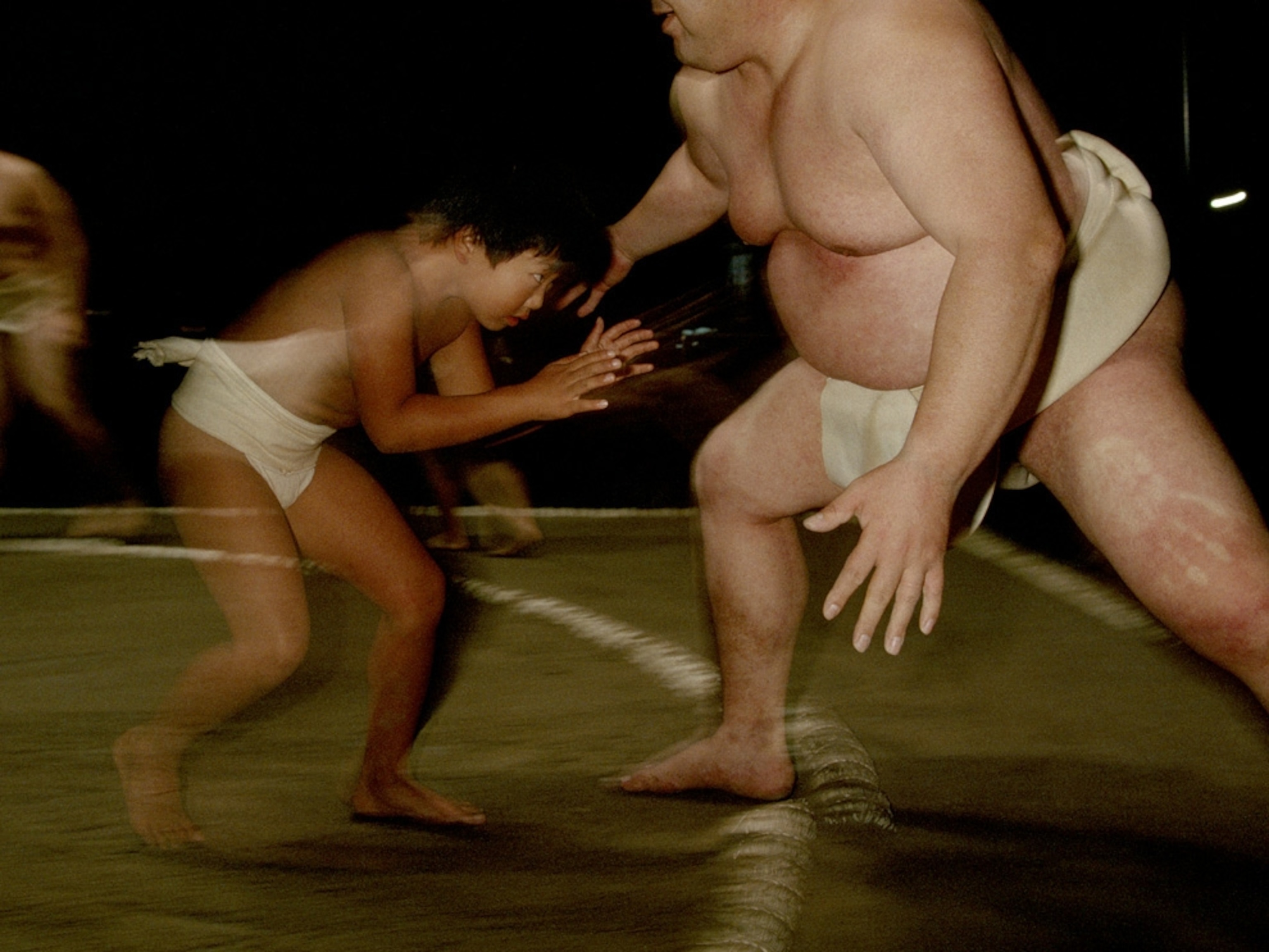 Sumo wrestler and boy wrestling