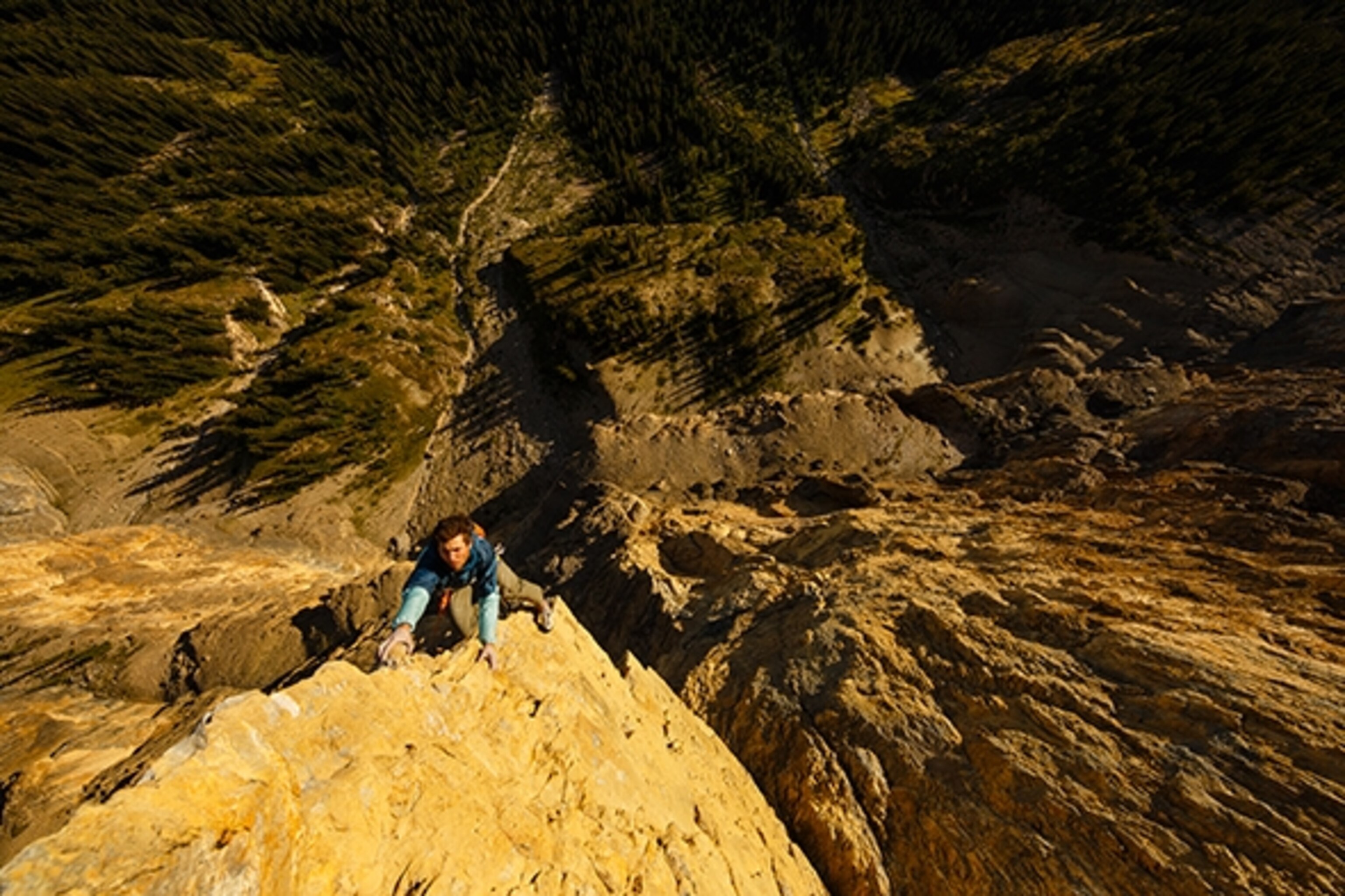Sonnie Trotter climbing the crux pitch of his stunning new route called Castles in the Sky, a 5 pitch 5.14 on Castle Mountain near Banff, Alberta, Canada. Sam Lambert is belaying.; Photograph by Ben Moon