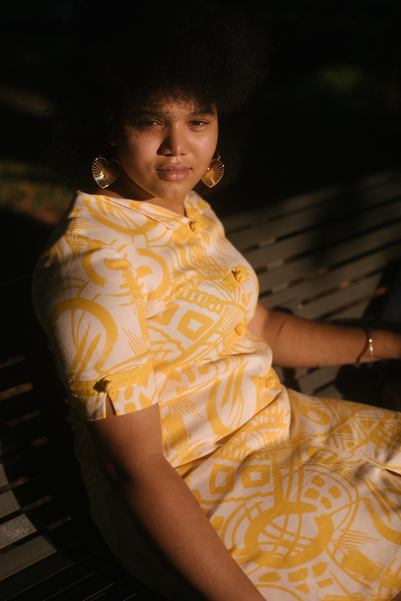 Portrait of a young woman wearing a yellow dress