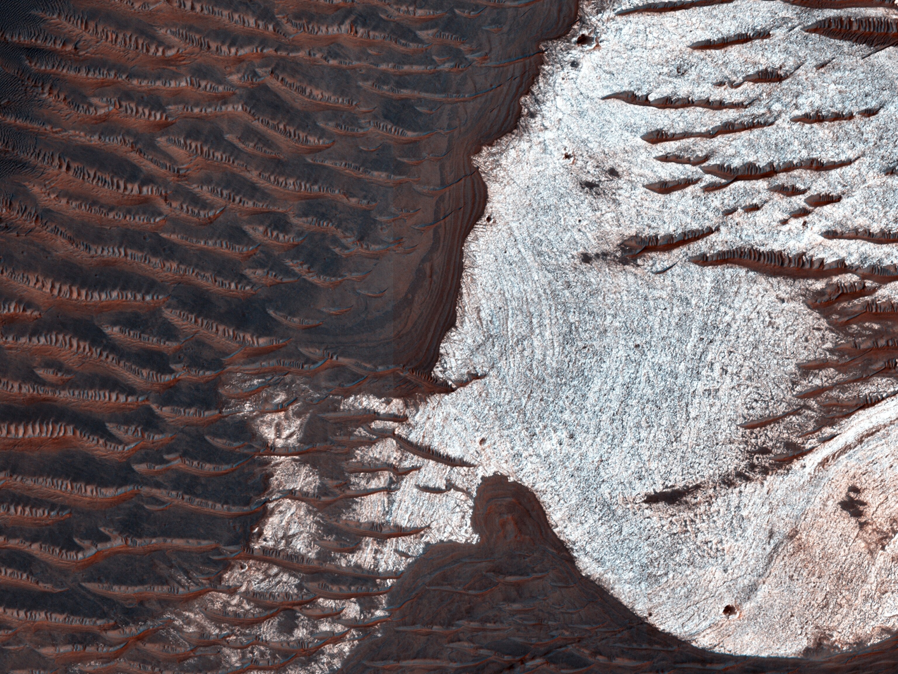 The bright rocks in this image have minerals that contain water. These water-bearing minerals are found using the companion instrument on the MRO spacecraft called CRISM.