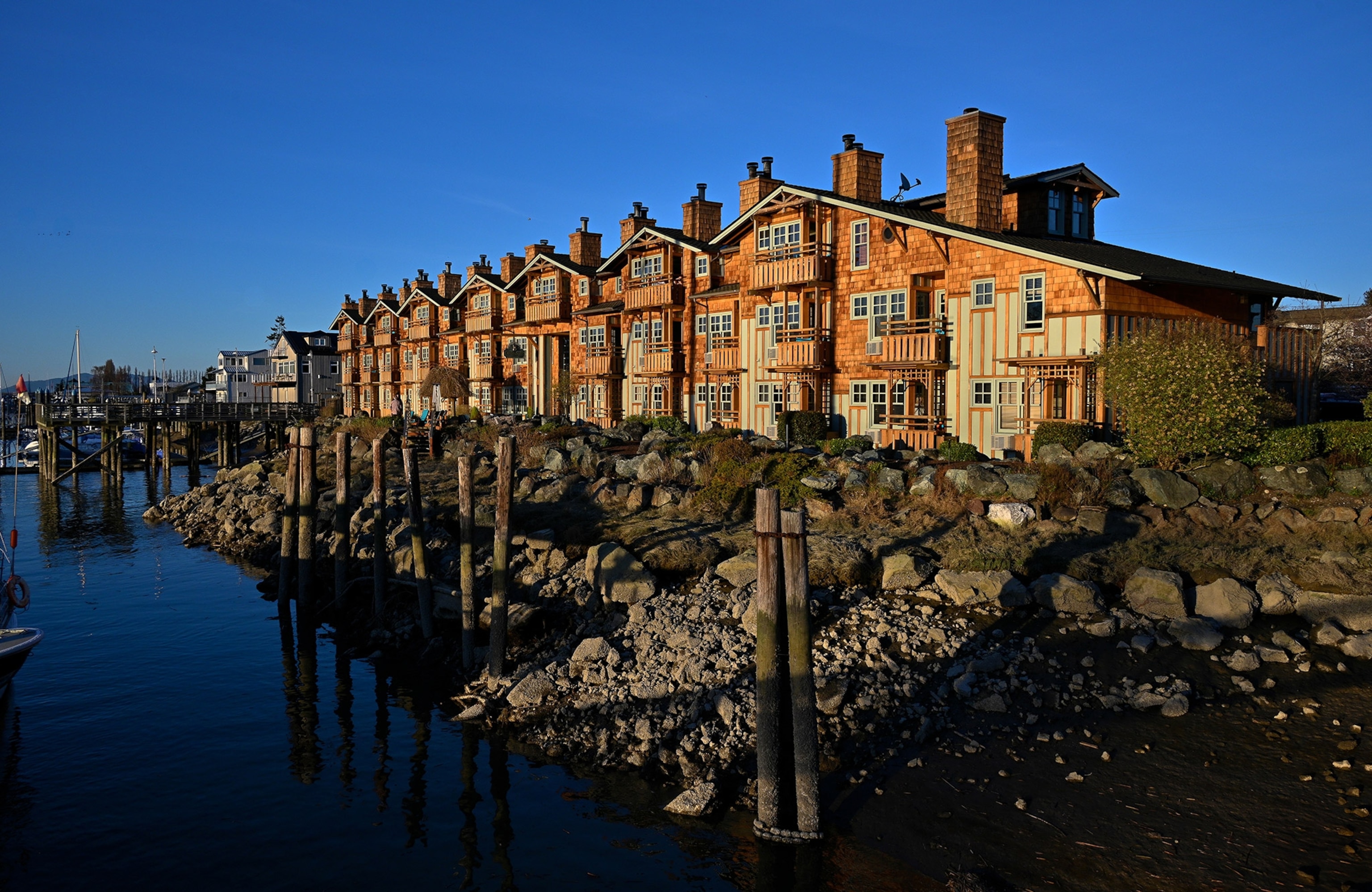 A sun-lit building at water's edge