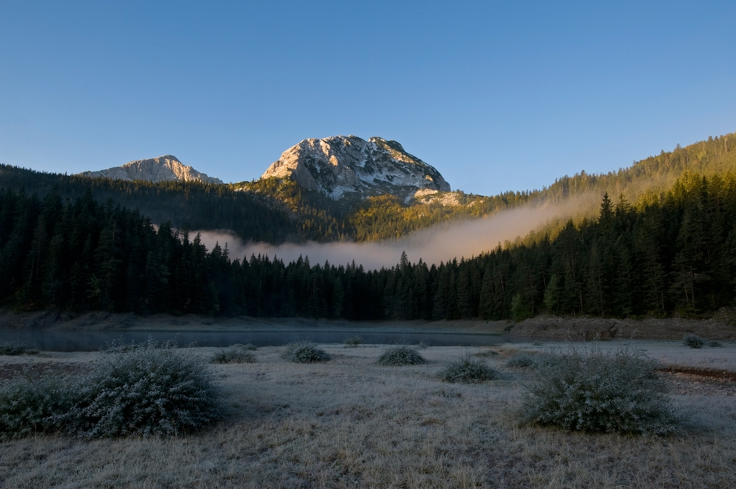 A lake and a mountain in the distance