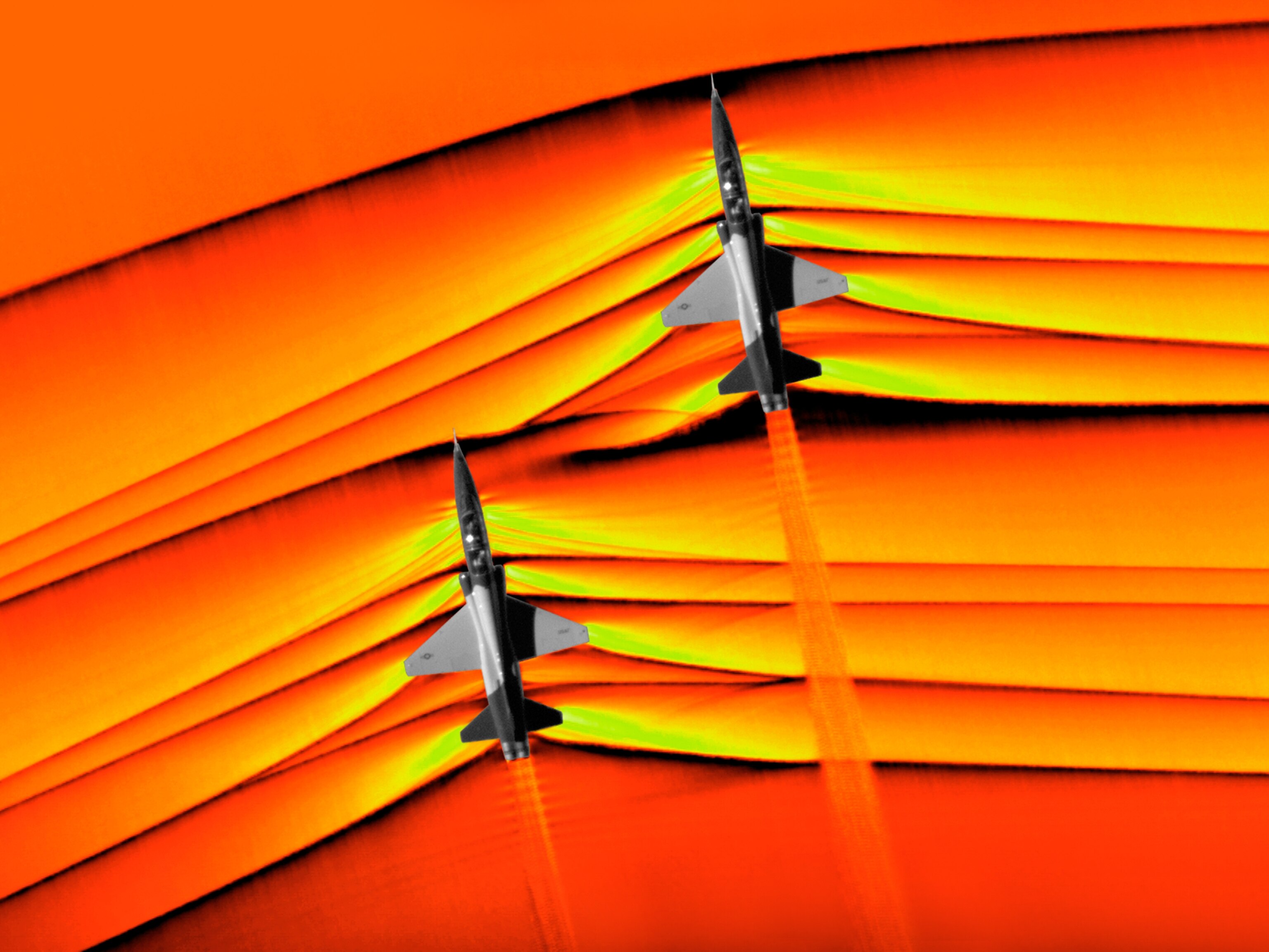 A colorizing effect shows shock waves emanating from a supersonic US T-38 Talon aircraft