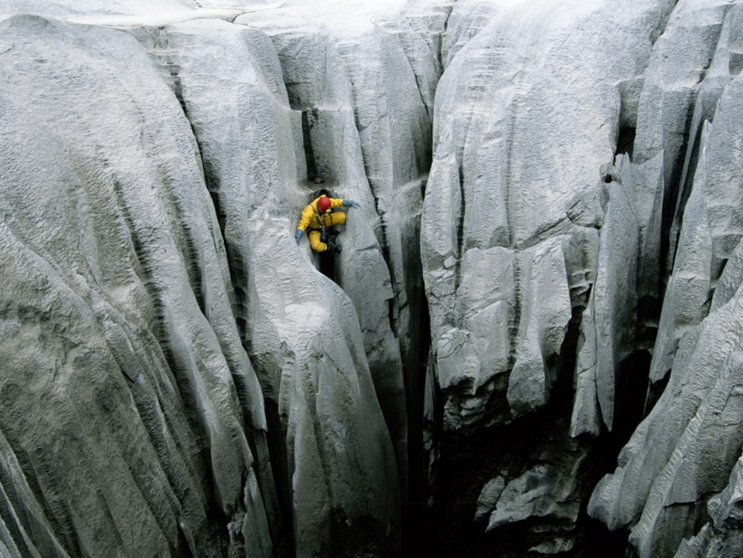 Caver descending a wall