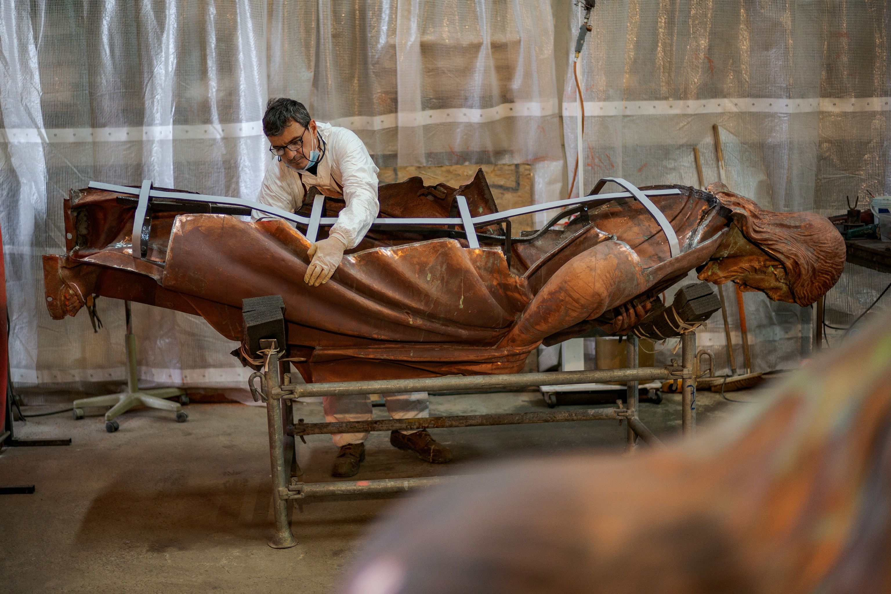 A man works on a statue