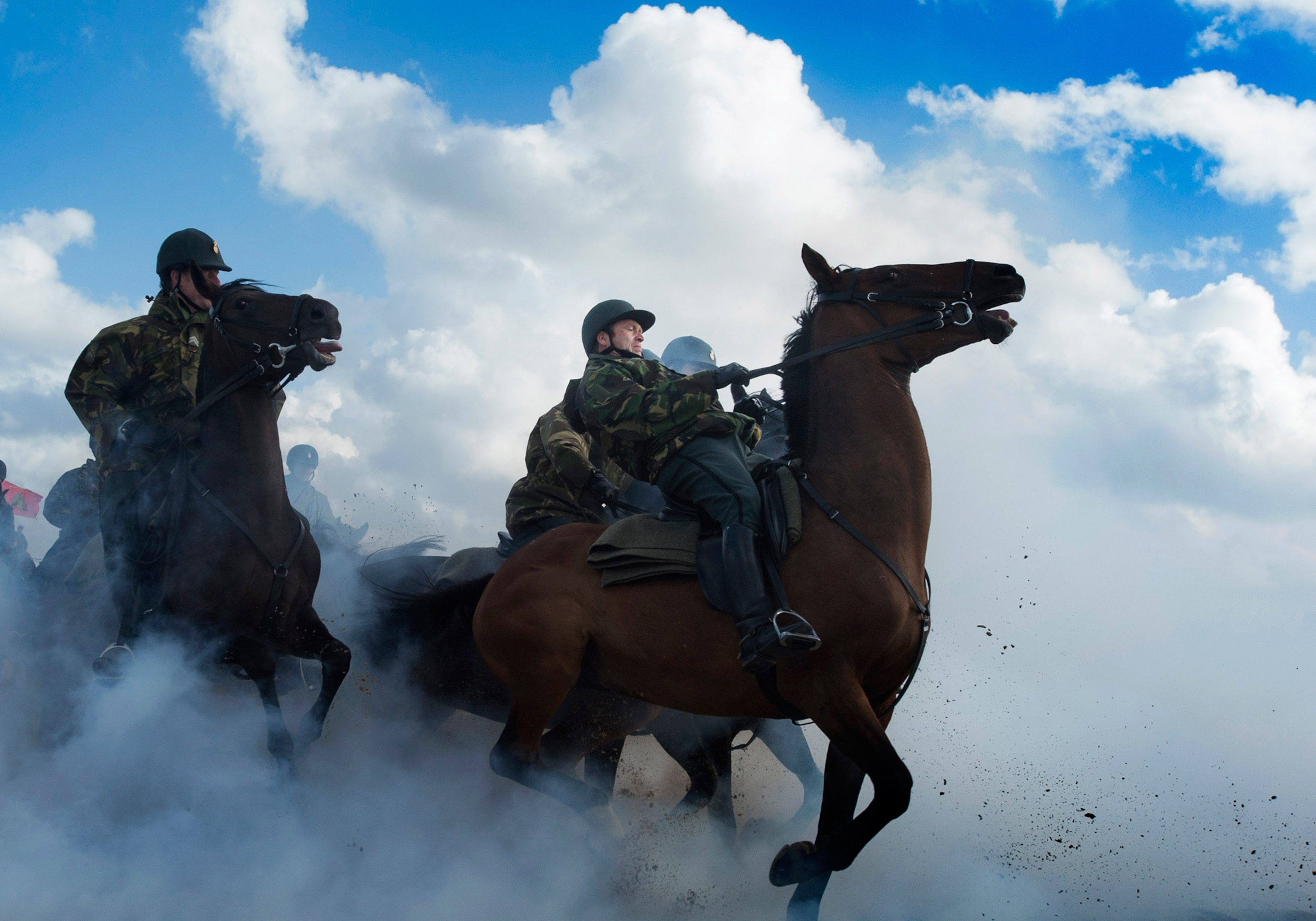 Pictures We Love - Picture of members of the Dutch Royal Guard of Honour riding horses through thick smoke