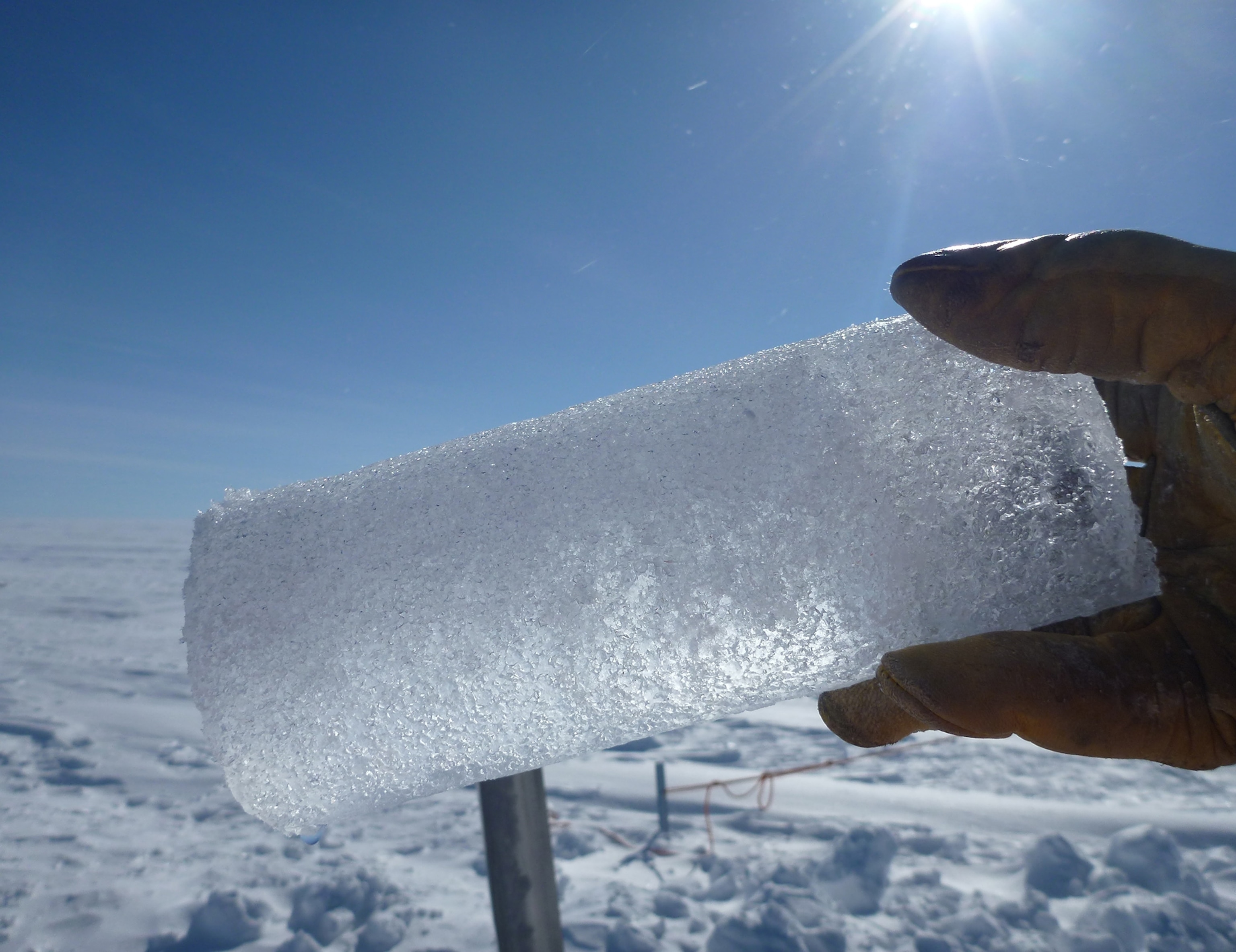 An ice core segment with water taken from the underground aquifer discovered in Greenland.