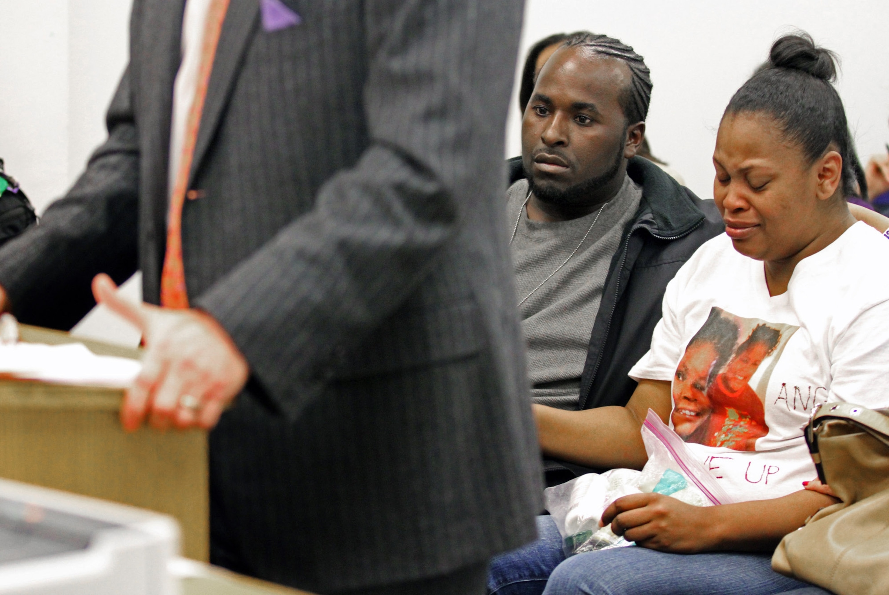 Nailah Winkfield, mother of 13-year-old Jahi McMath, right, is comforted by her husband Martin Winkfield and another family member as they wait for a hearing to start in Department 31 in the Post Office Building Friday, Dec. 20, 2013 in Oakland, Calif.